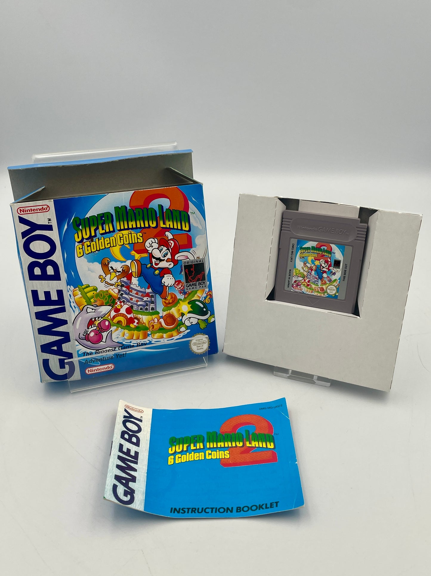 Game Boy cartridge with packaging and instruction booklet on a white background