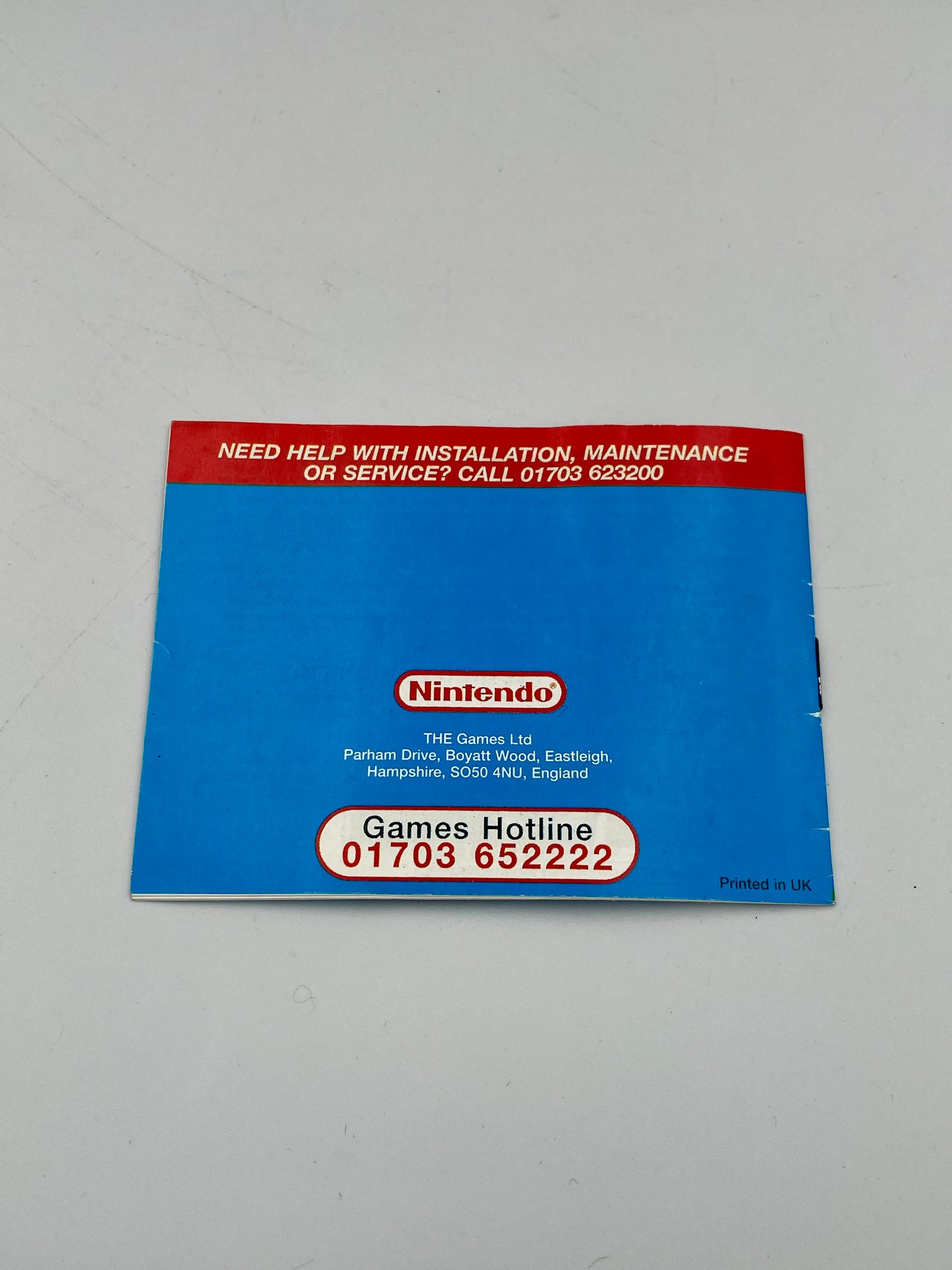 Nintendo support card with contact information on a gray background