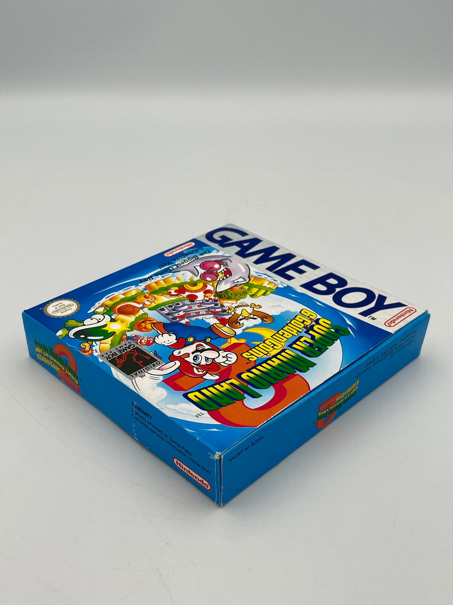Box of Nintendo Game Boy with colorful graphics on a gray background