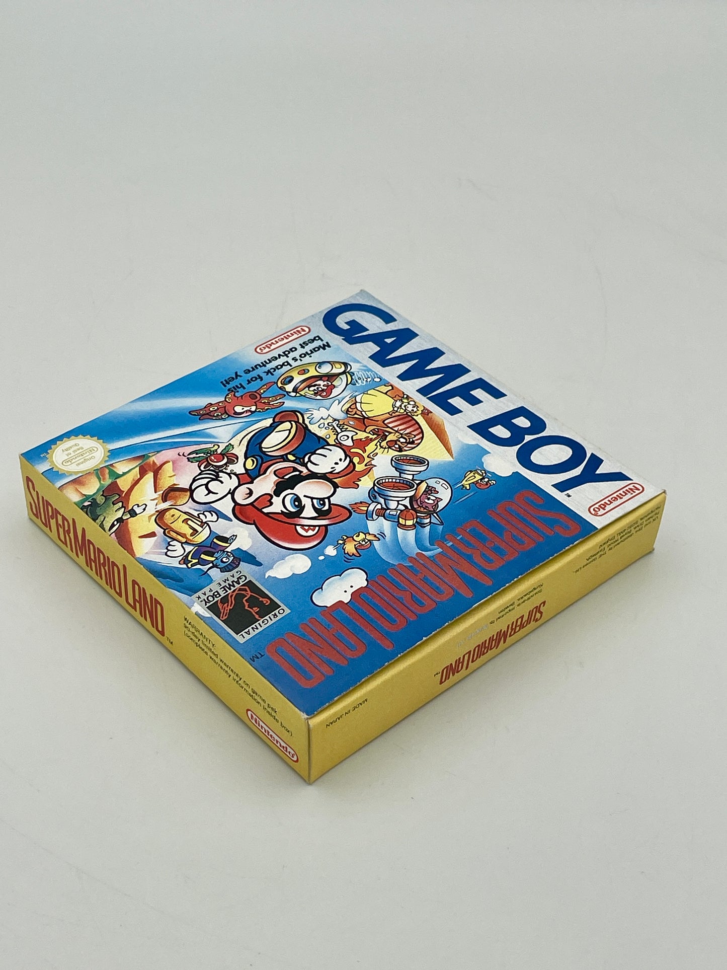 Super Mario Bros Game Boy packaging on a gray background