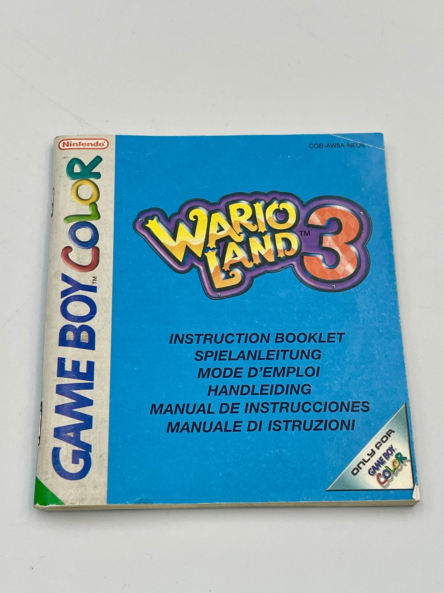 Instruction booklet for Wario Land 3 on Game Boy Color with colorful text and logo.