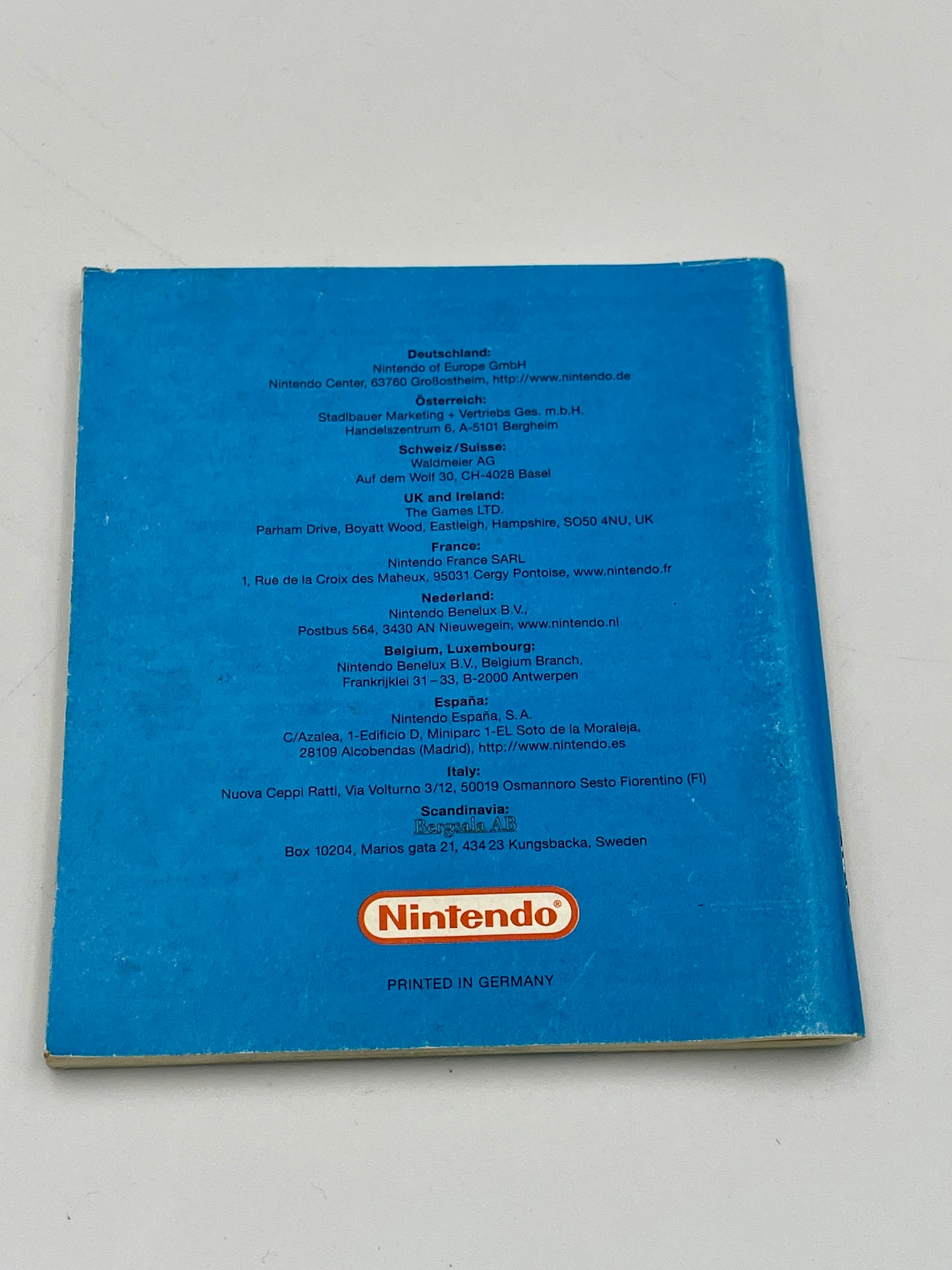 Blue book with Nintendo logo on a white background