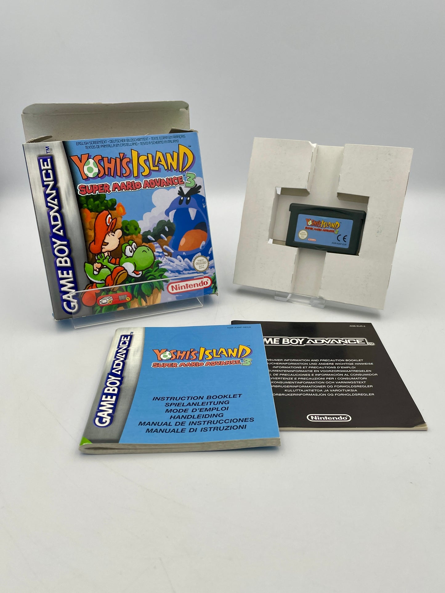 Nintendo Game Boy Advance game 'Yoshi's Island' with manual and cartridge on a white background