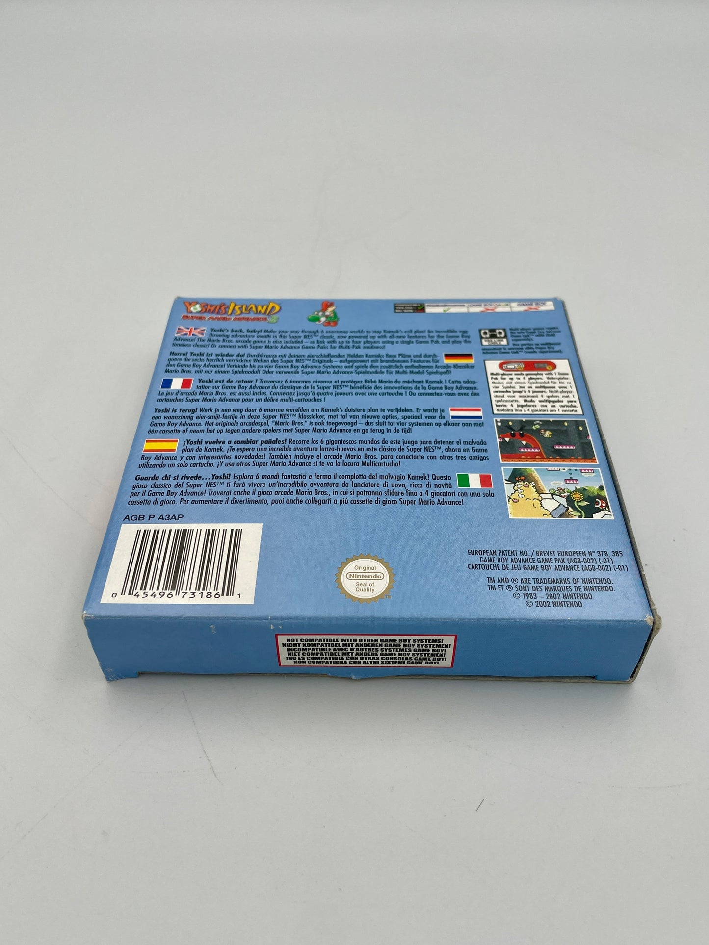 Back view of a blue game cartridge packaging with text and graphics on a gray background