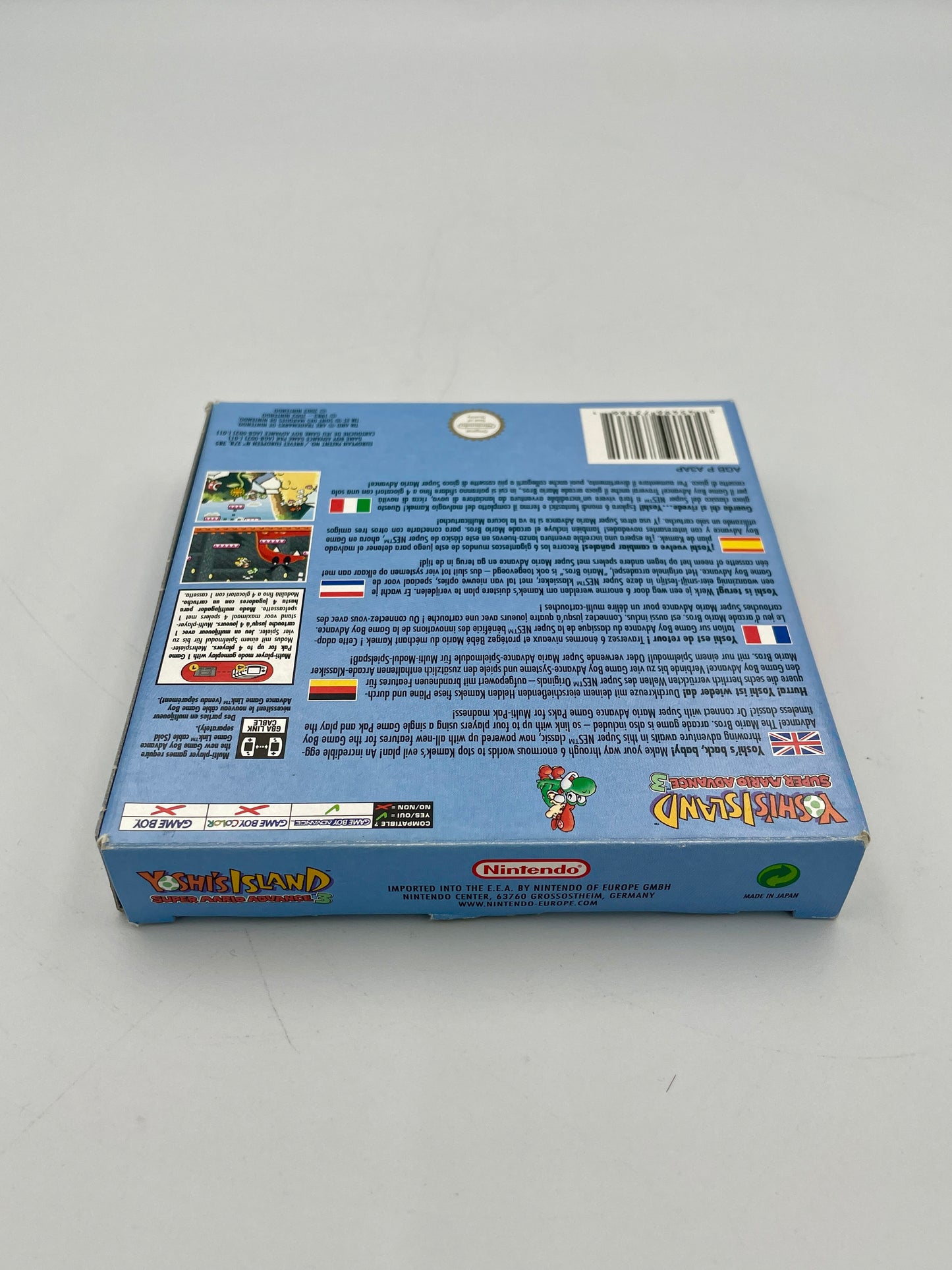 Back view of a blue box with text and graphics on a gray background