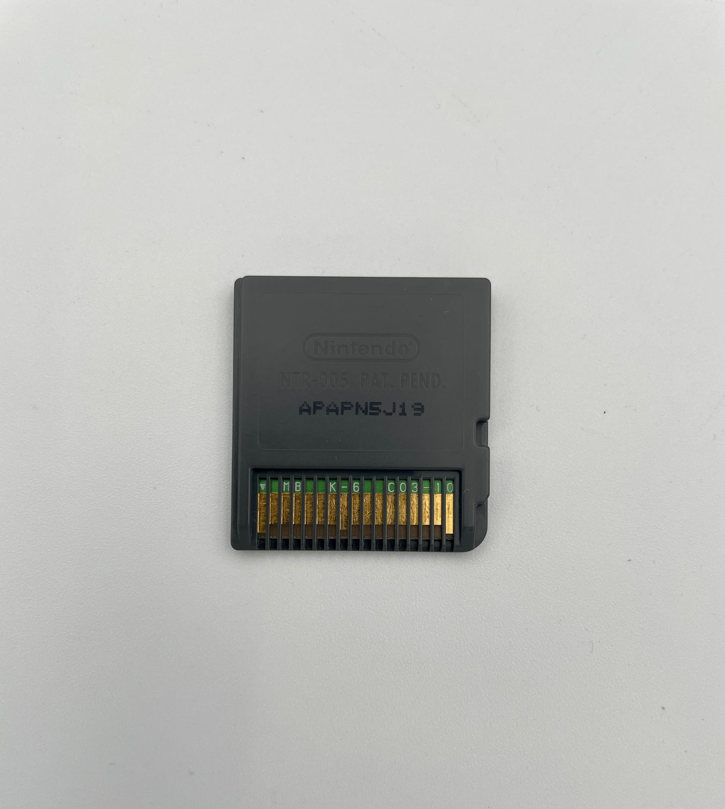 Black Nintendo GameCube memory card on a light gray background