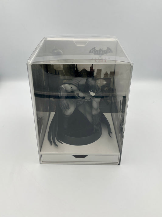 Statue of batman in a clear box on a white background