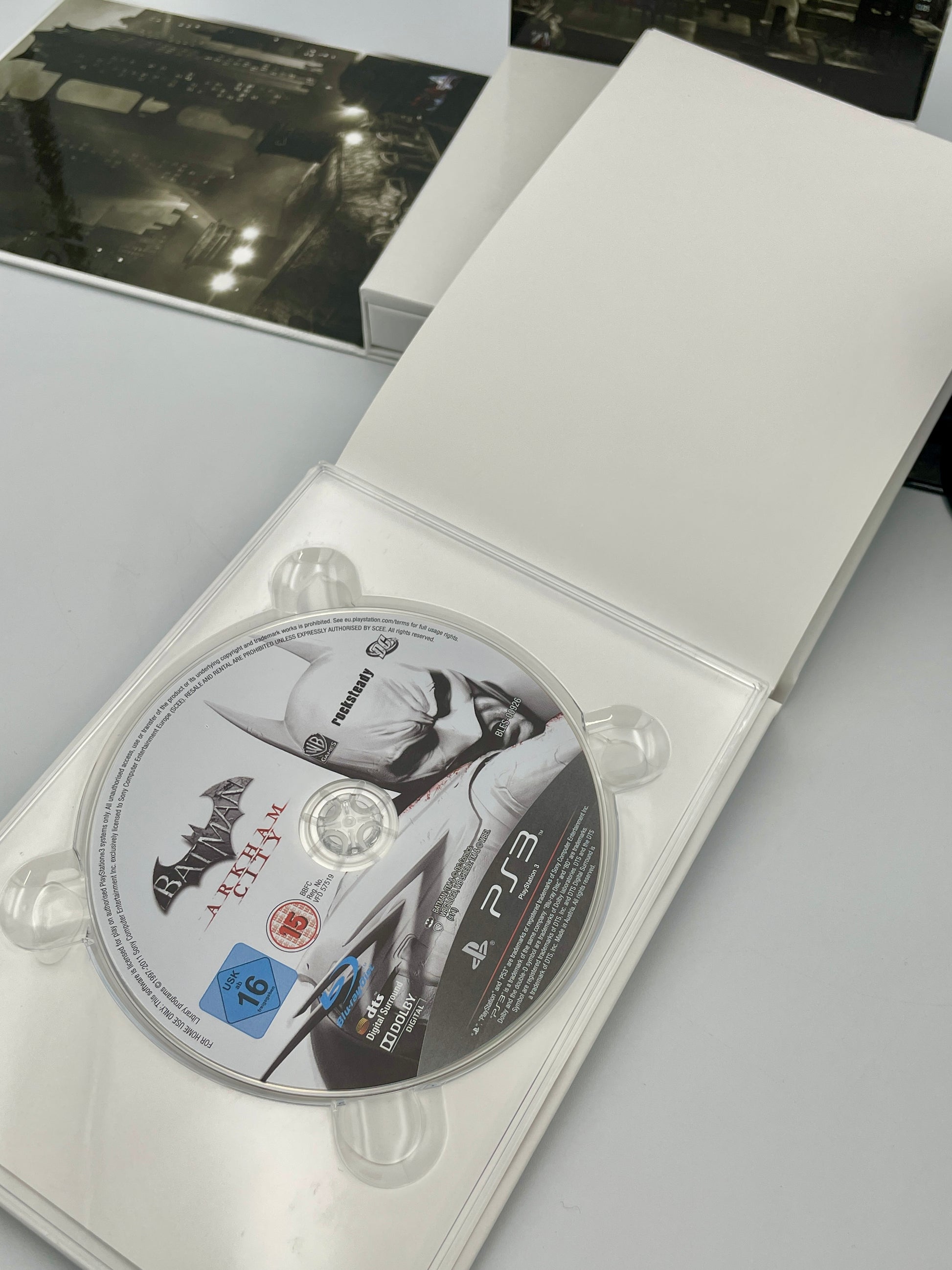 PlayStation 3 game disc inside a white case with a black and white image on the cover.