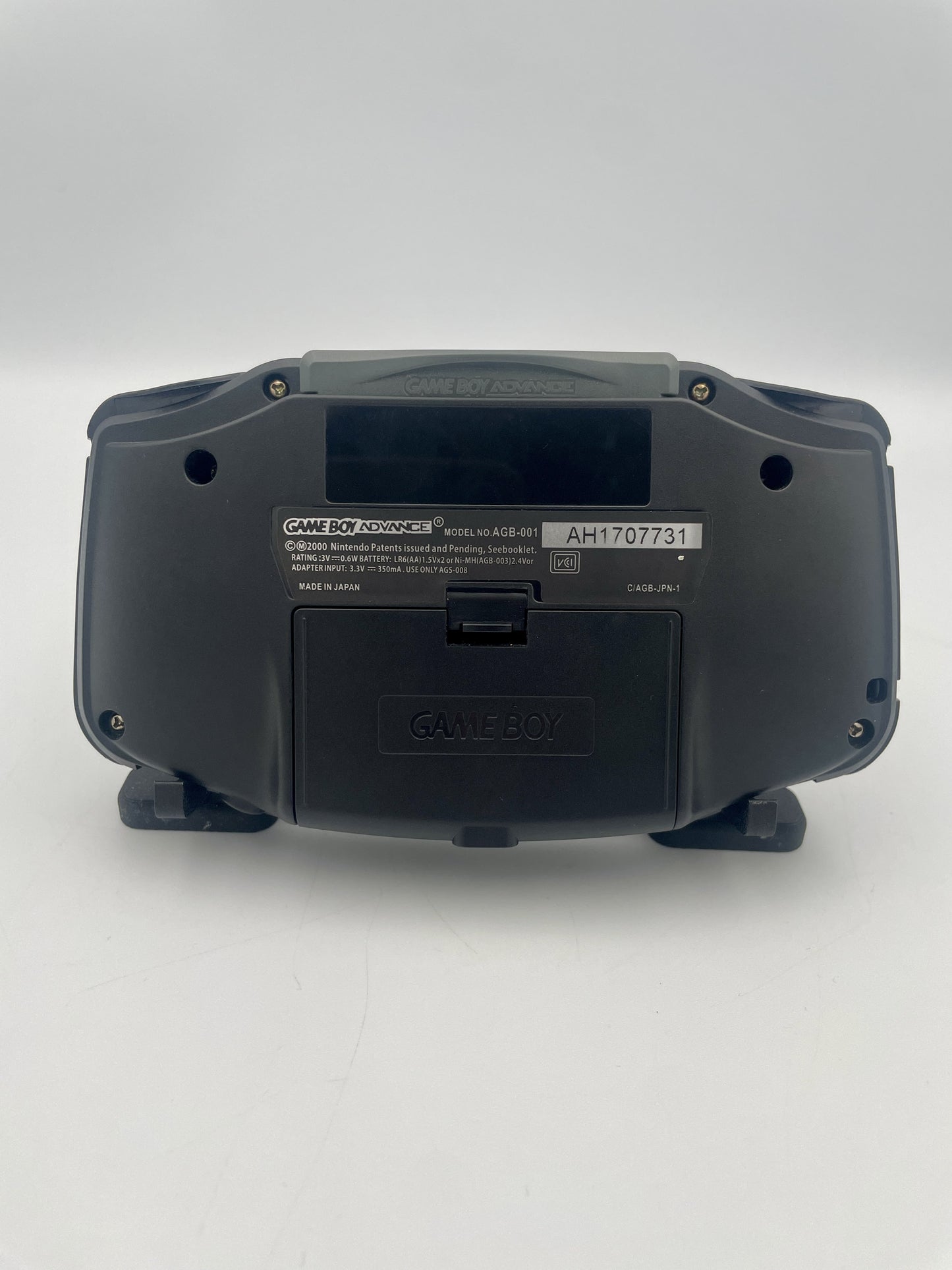 Back view of a black electronic device on a white background
