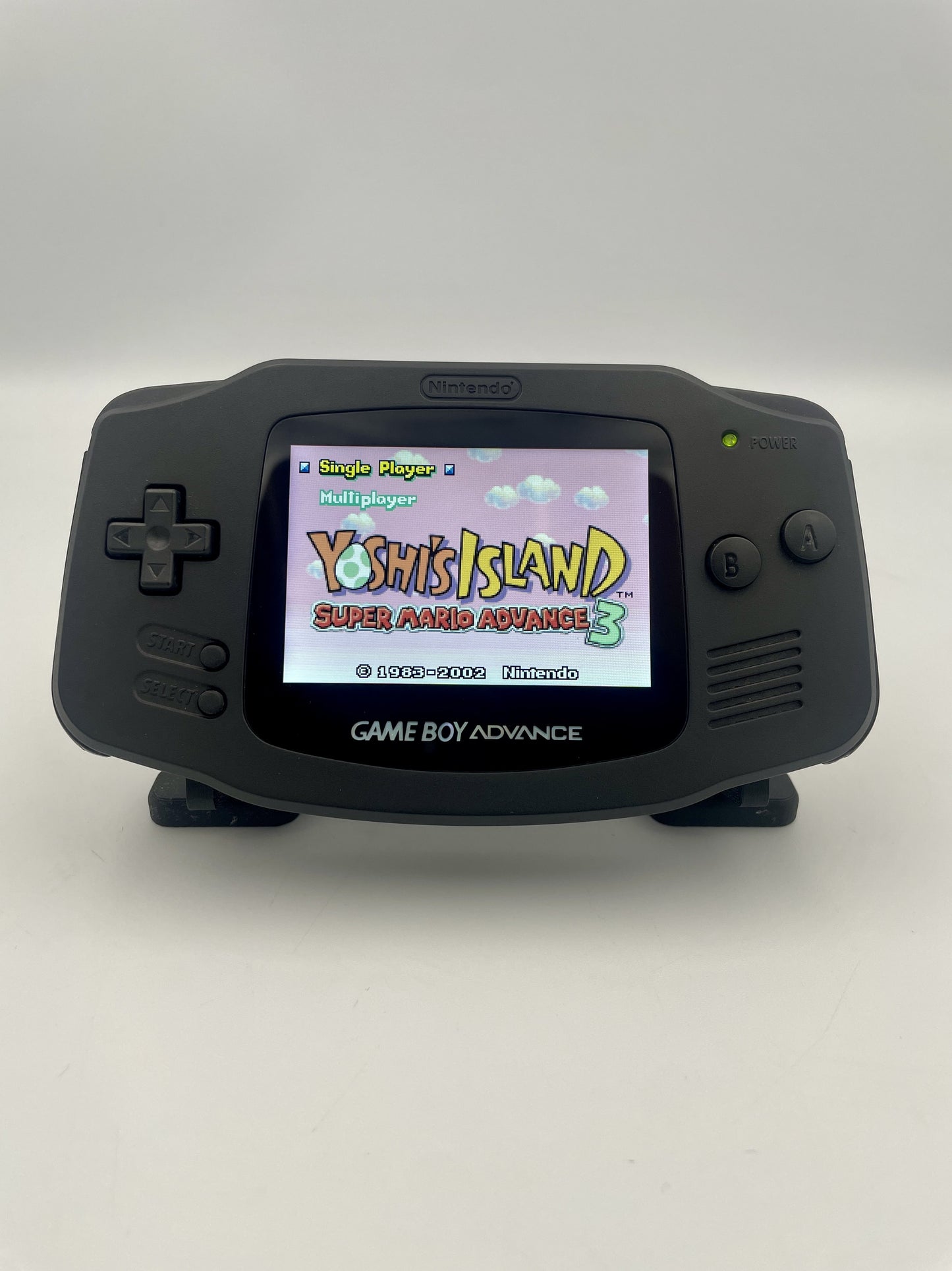 Game Boy Advance displaying 'Yoshi's Island' on a white background