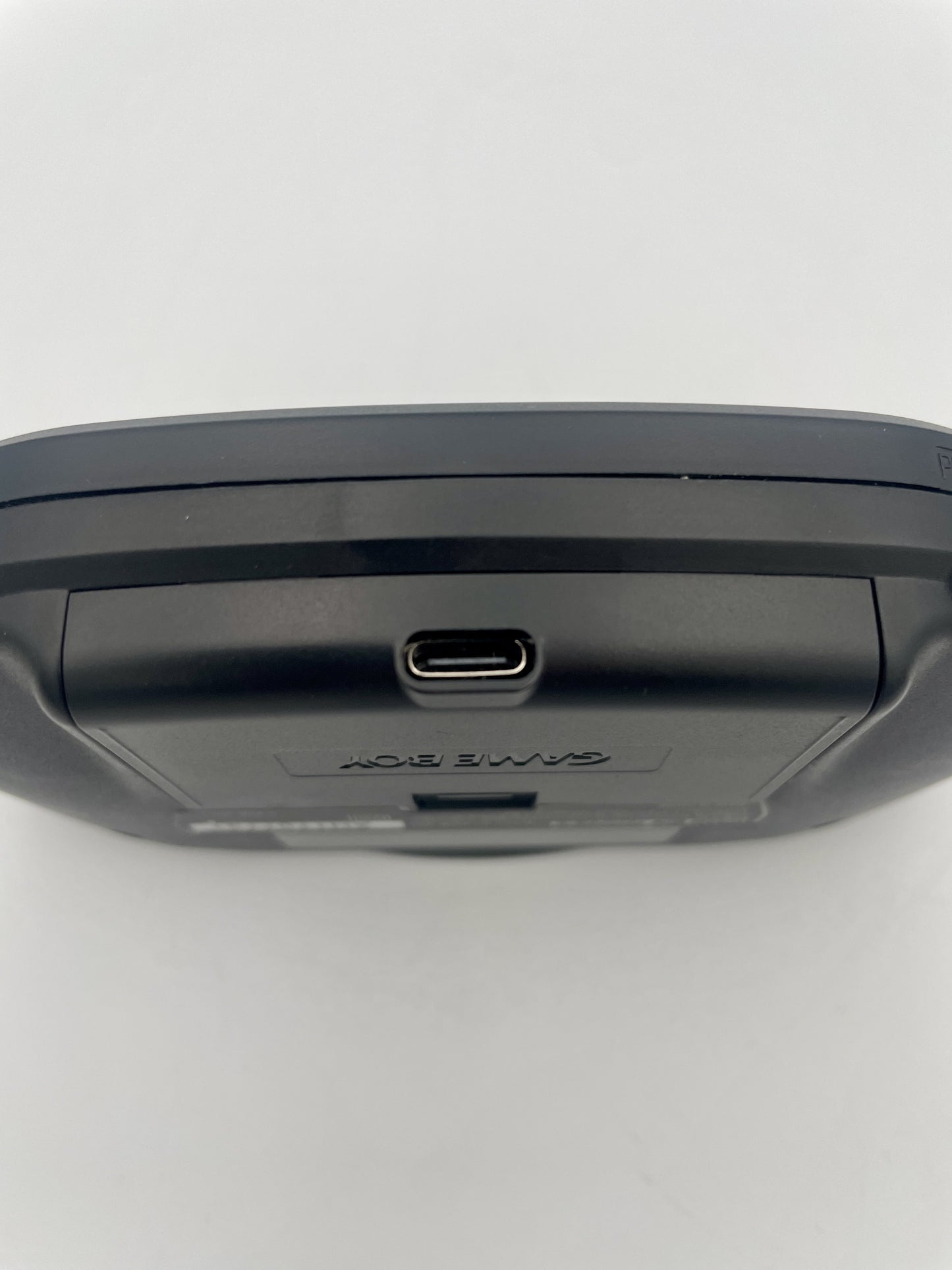 Black electronic device with USB port on a white background