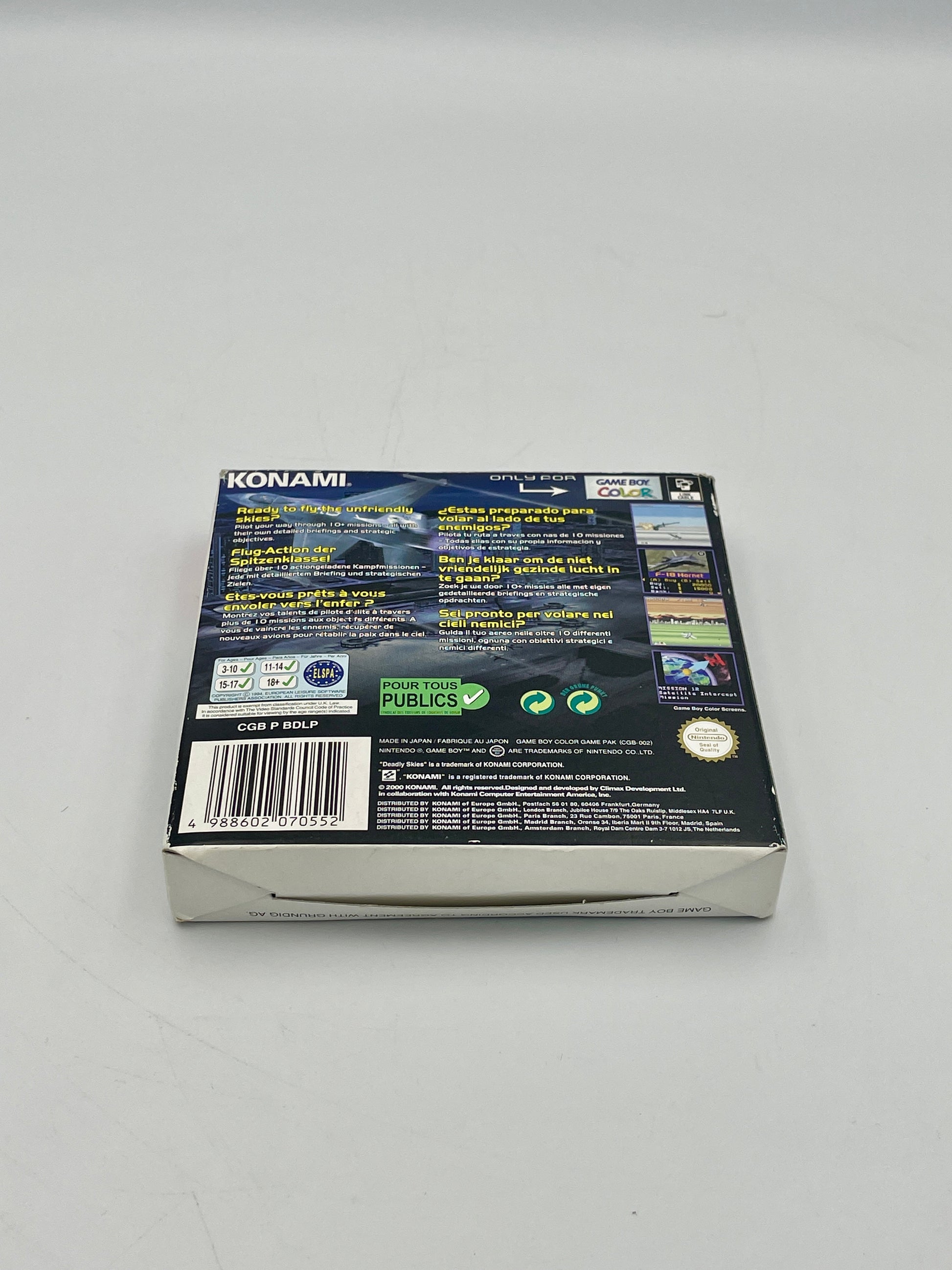 Back view of a Konami game box on a gray background