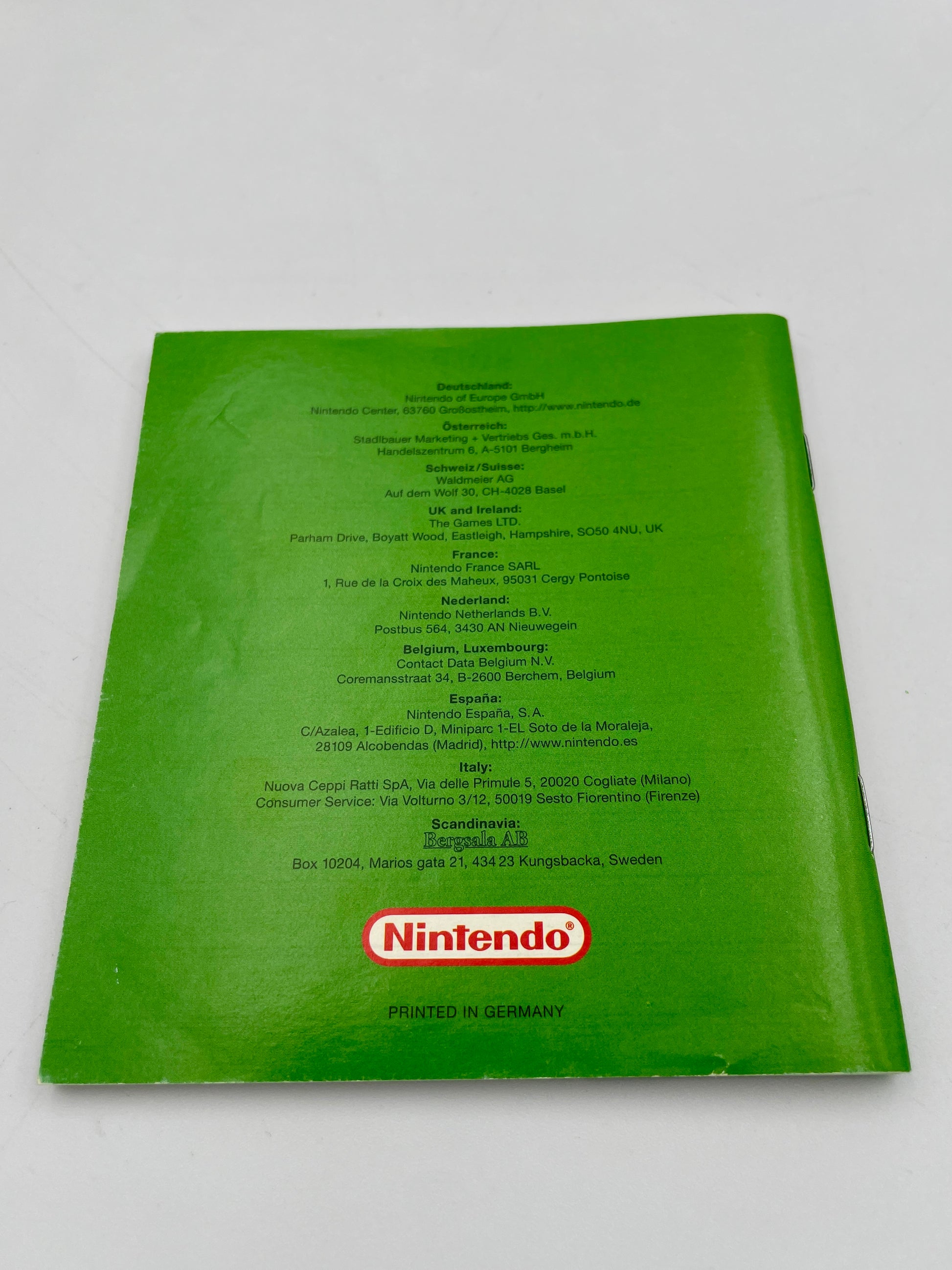 Green Nintendo product with text and logo on a white background
