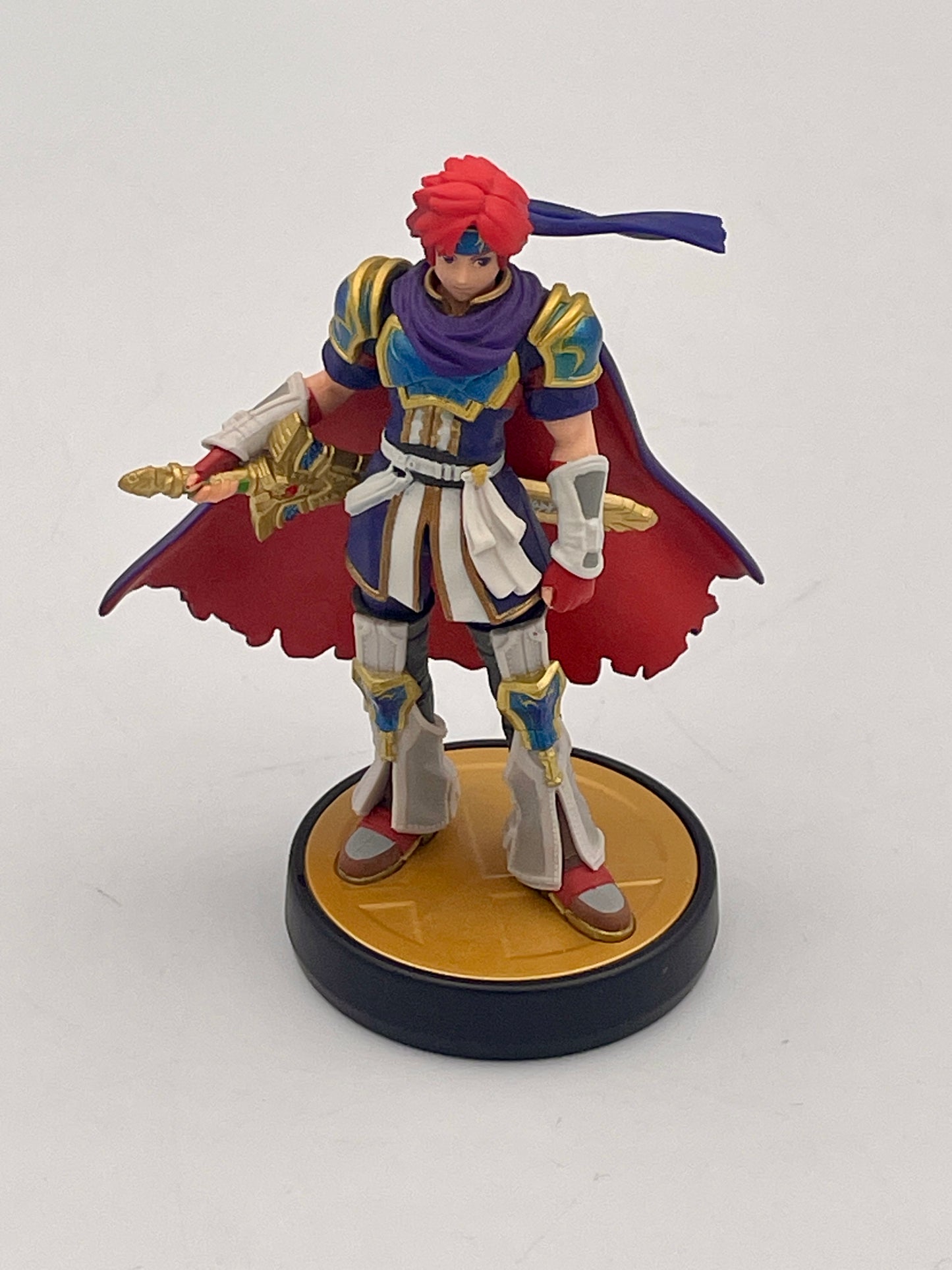 Figurine of a character with red hair and armor on a white background