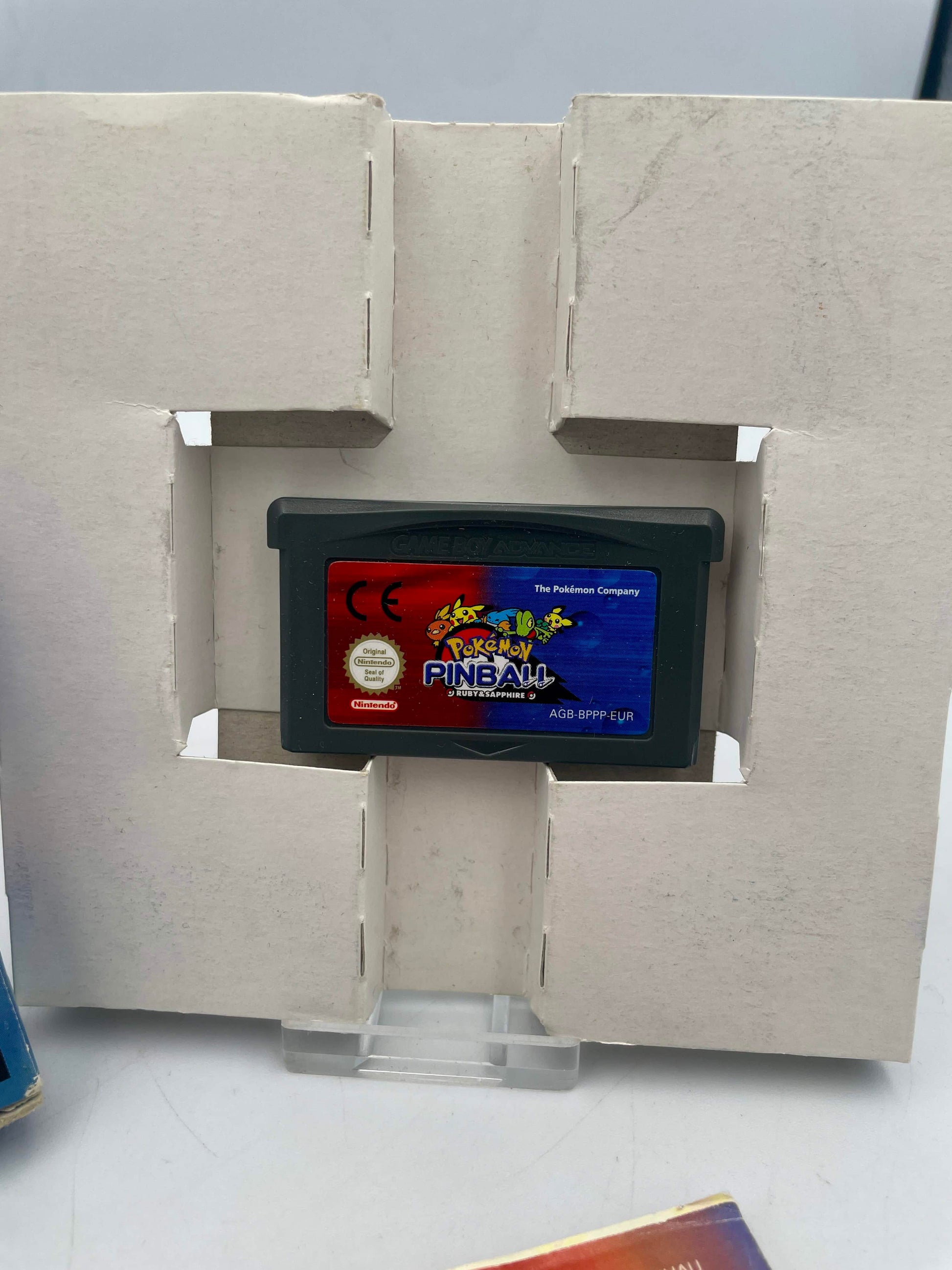 Game cartridge in a display stand with a concrete-like background