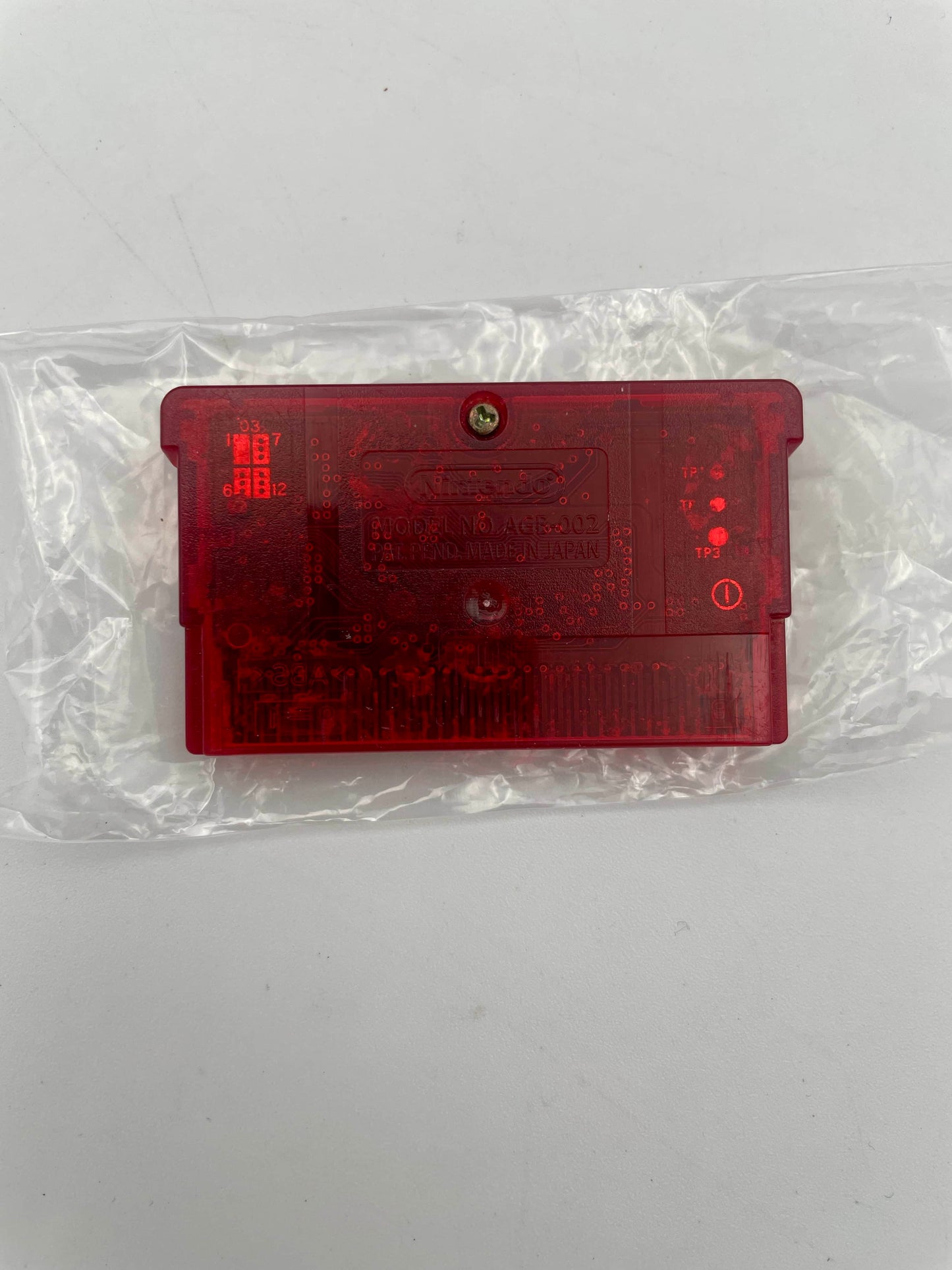 Red plastic component on a white background