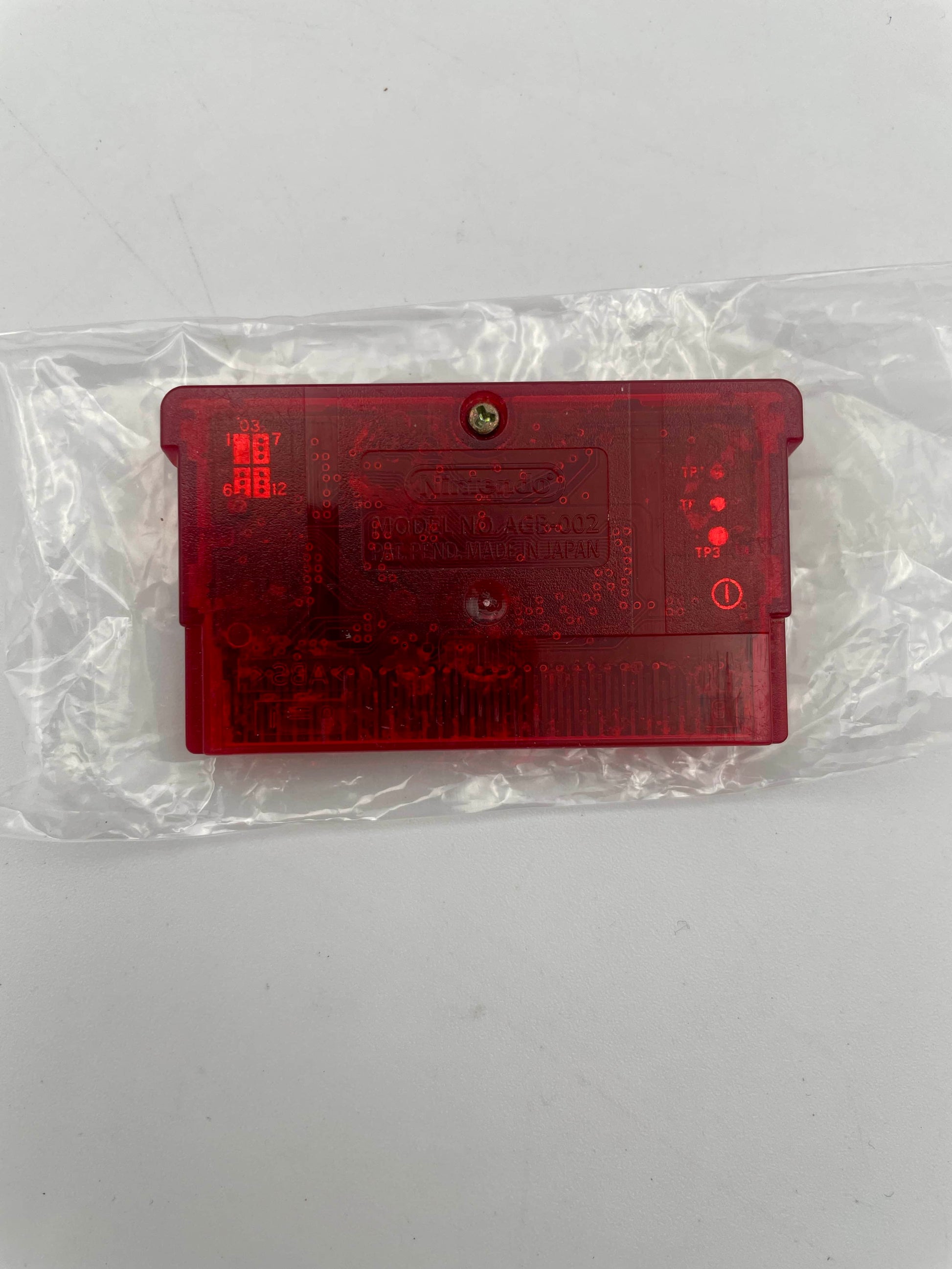 Red plastic component on a white background