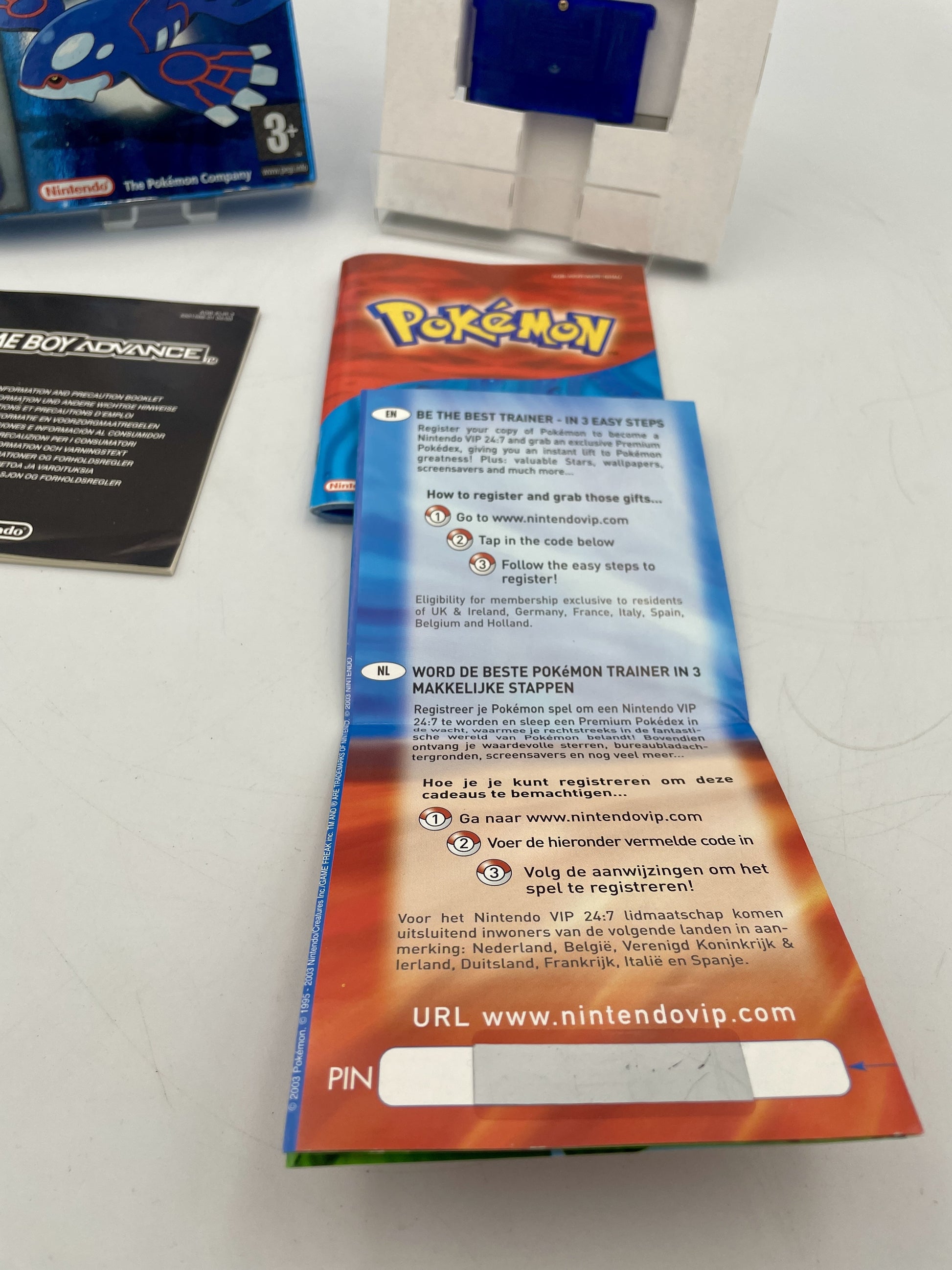 Pokémon trading card game packaging with branding and URL on a white background