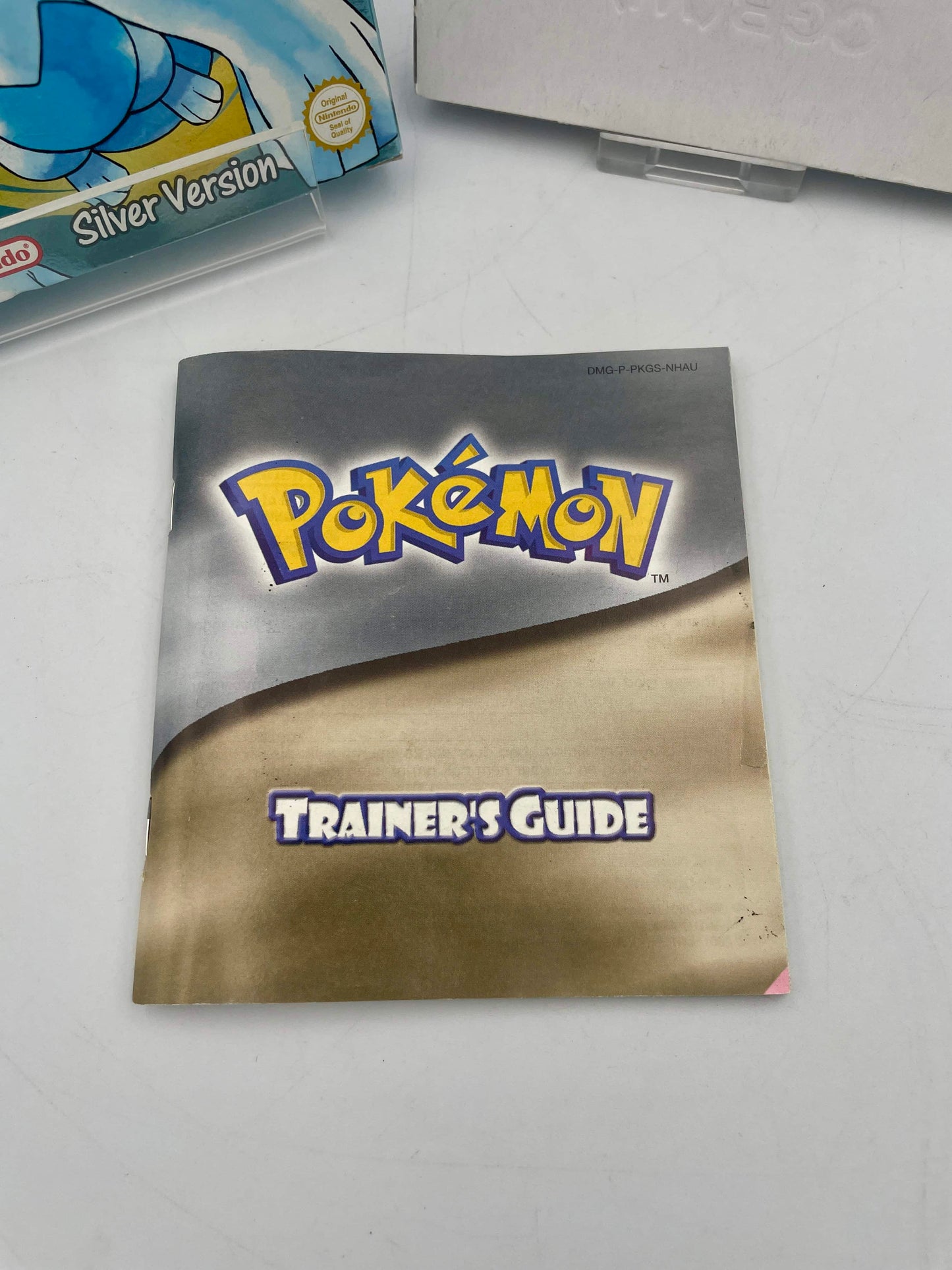 Pokémon Trainer's Guide on a white surface with a box in the background