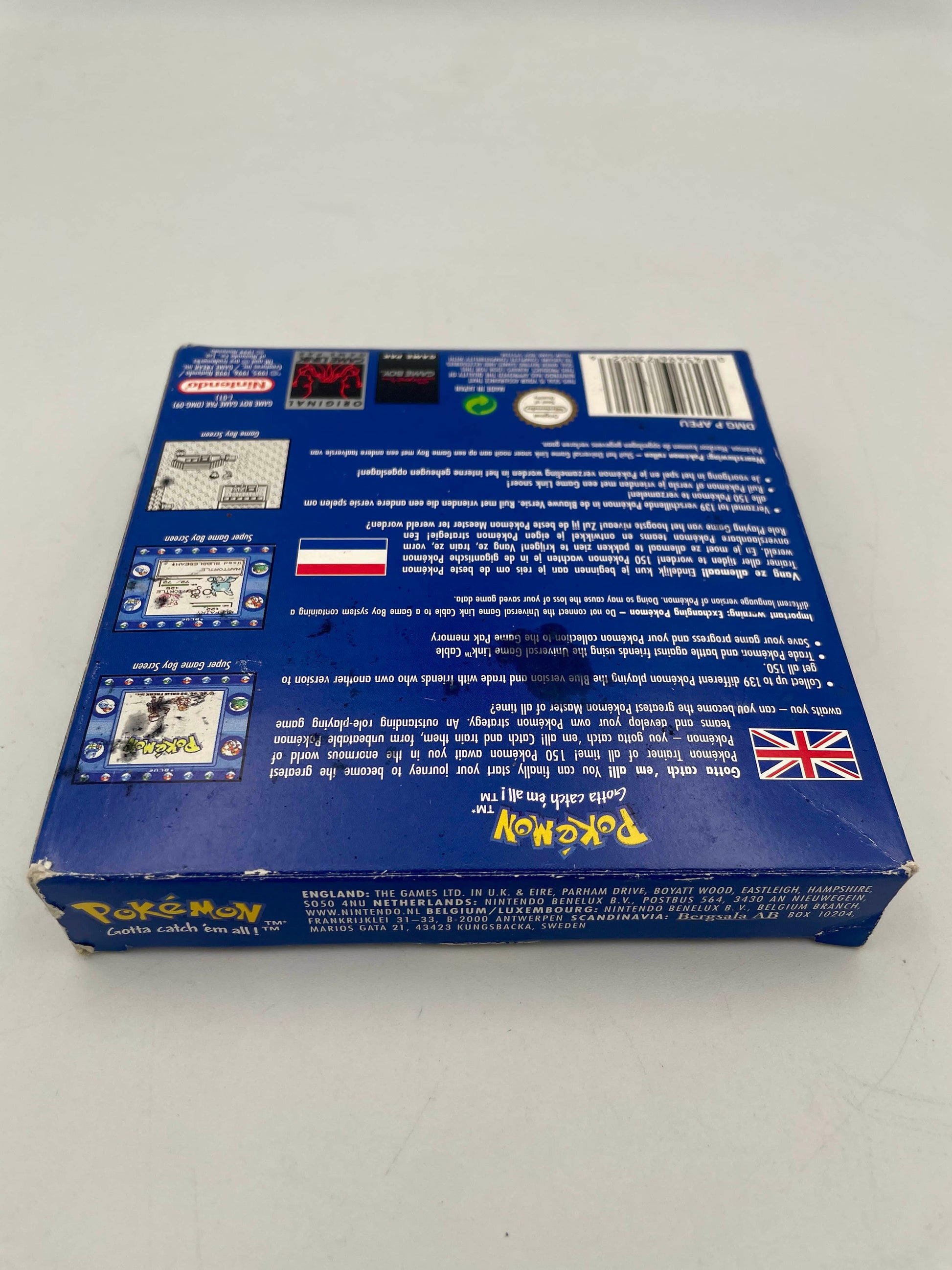 Back view of a blue box with text and a British flag on a white background