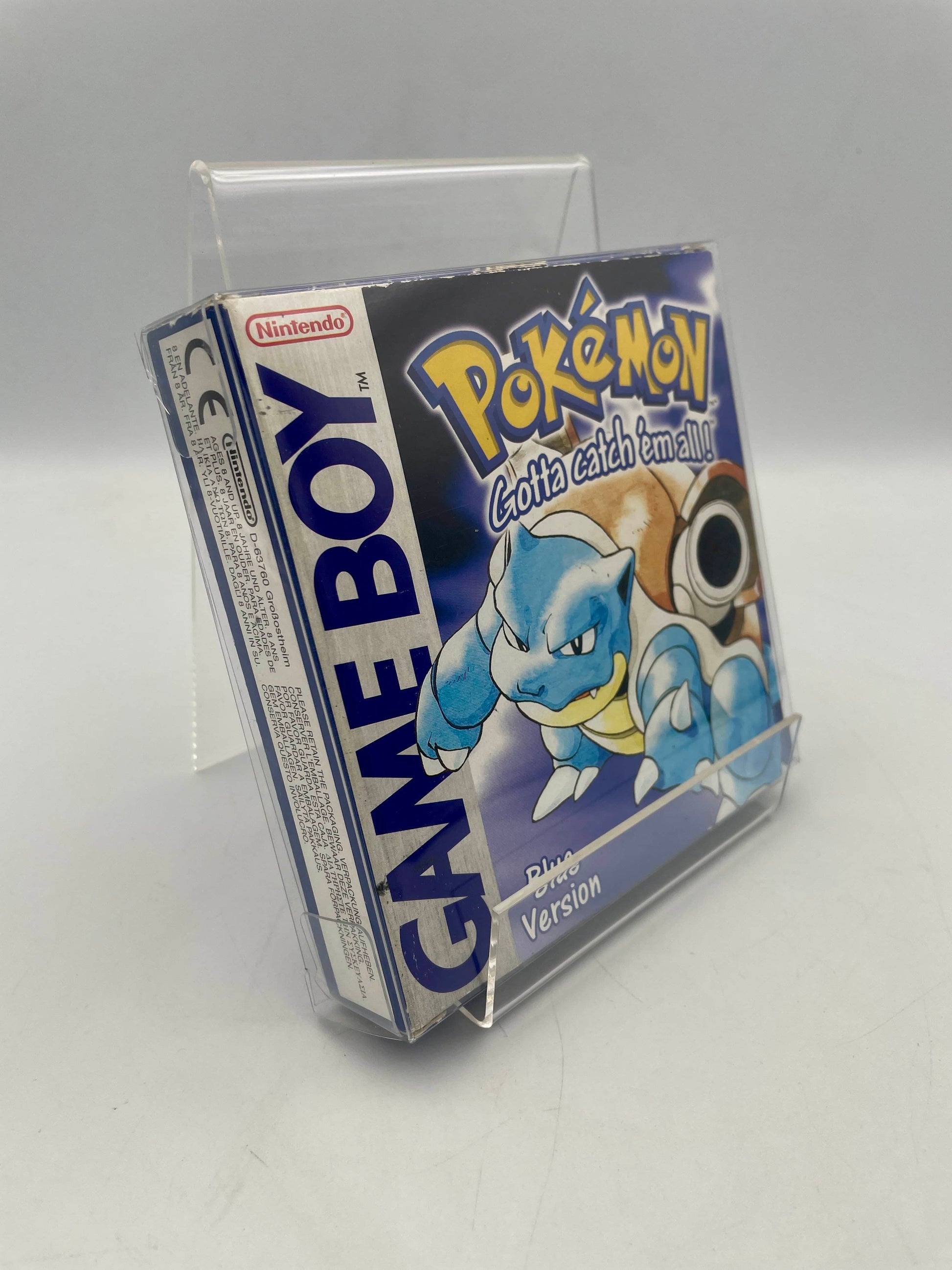 Pokémon Game Boy cartridge in a clear stand on a gray background