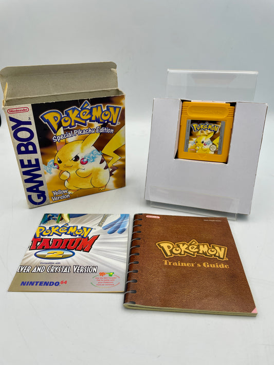 Collection of Pokémon-themed items including a Game Boy, trading card, and books on a white background