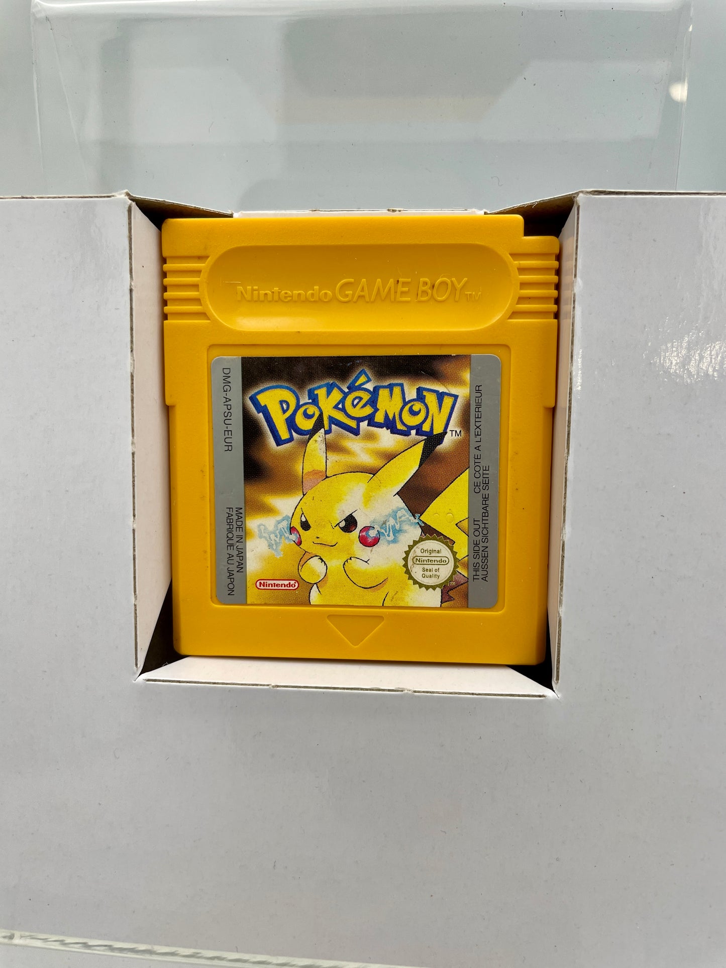 Yellow Game Boy cartridge with Pikachu on a gray background