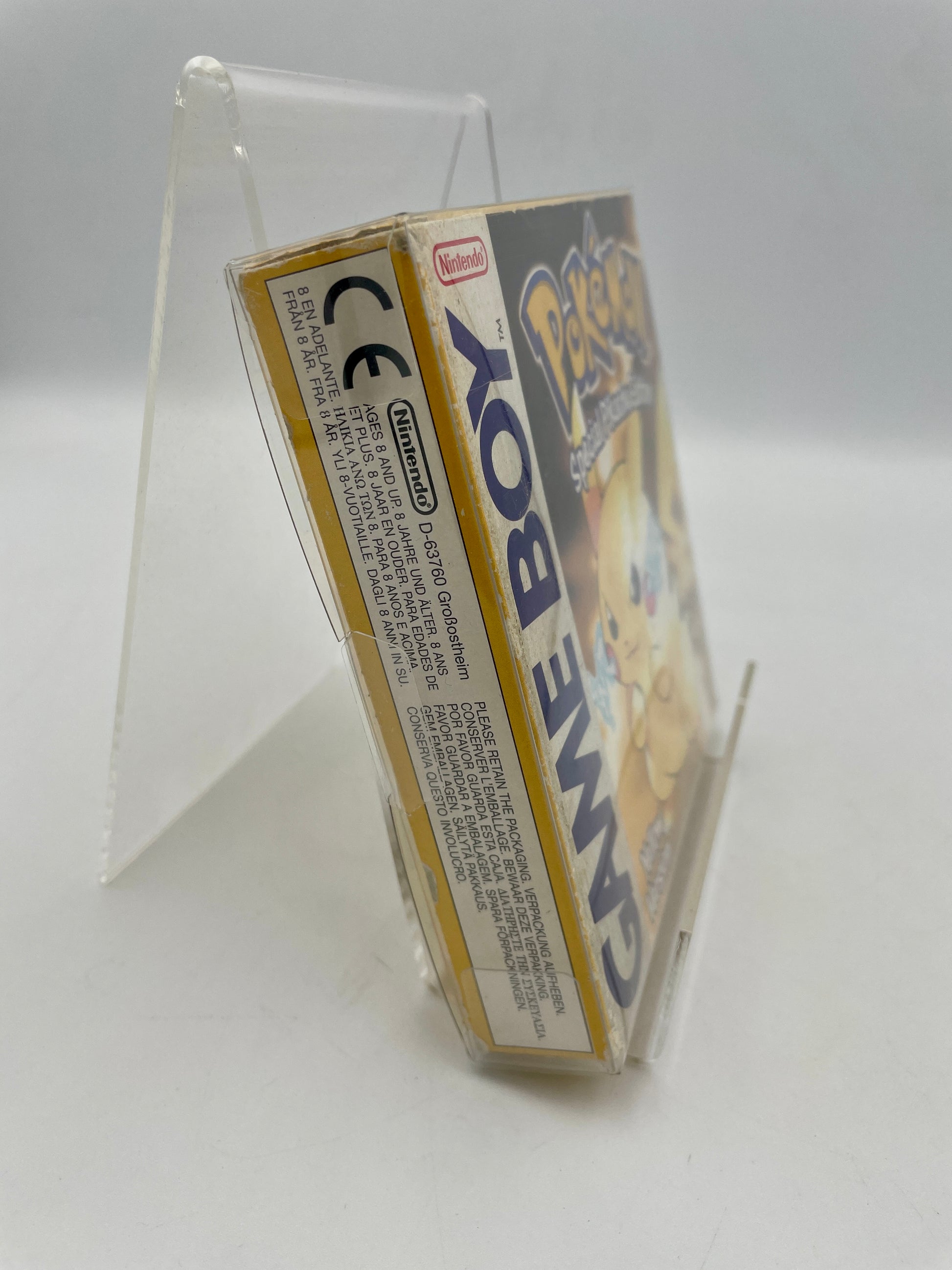 Game Boy packaging held by a clear stand on a white background