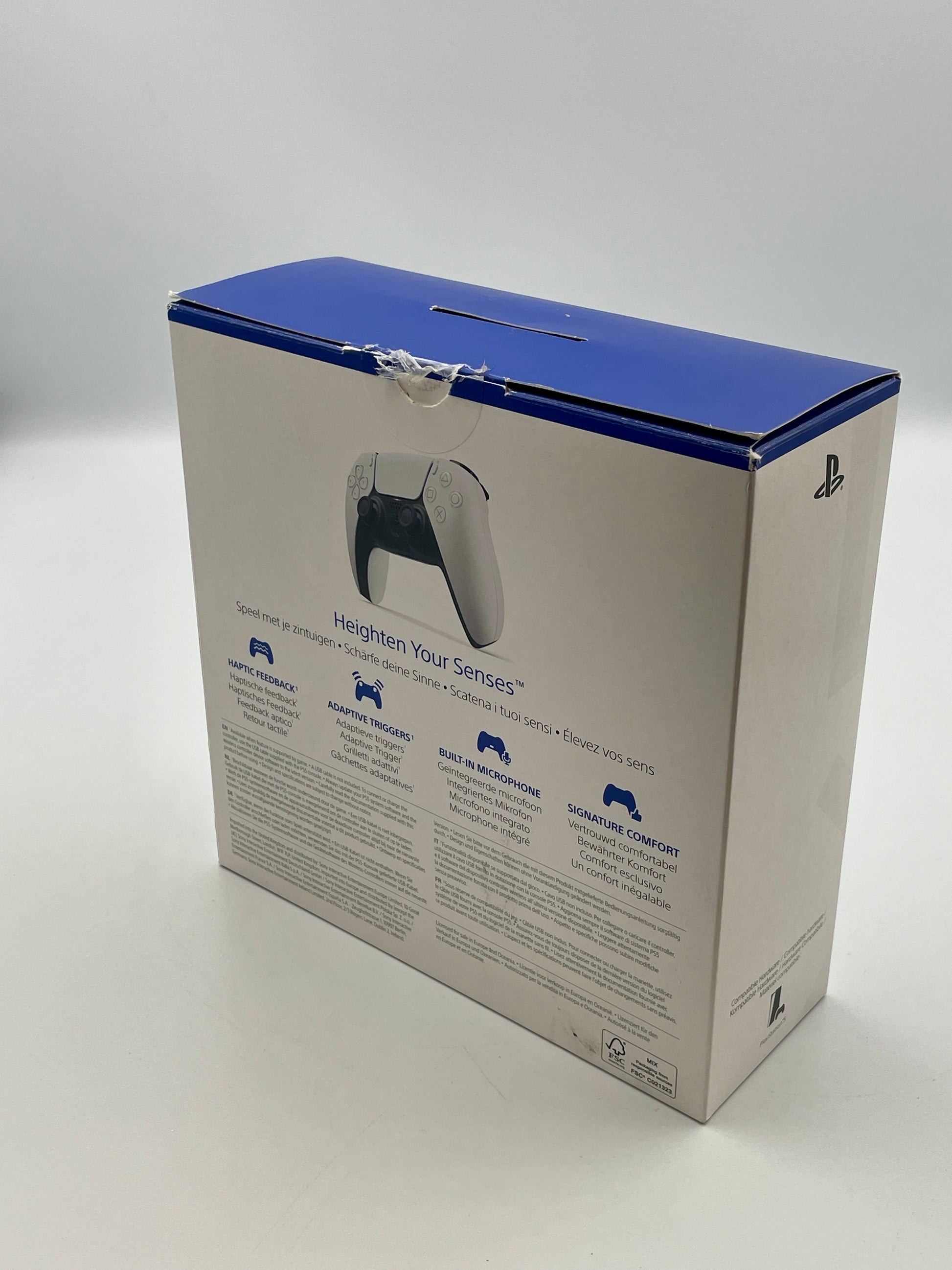 Gaming controller packaging box with blue top and white body on a gray background