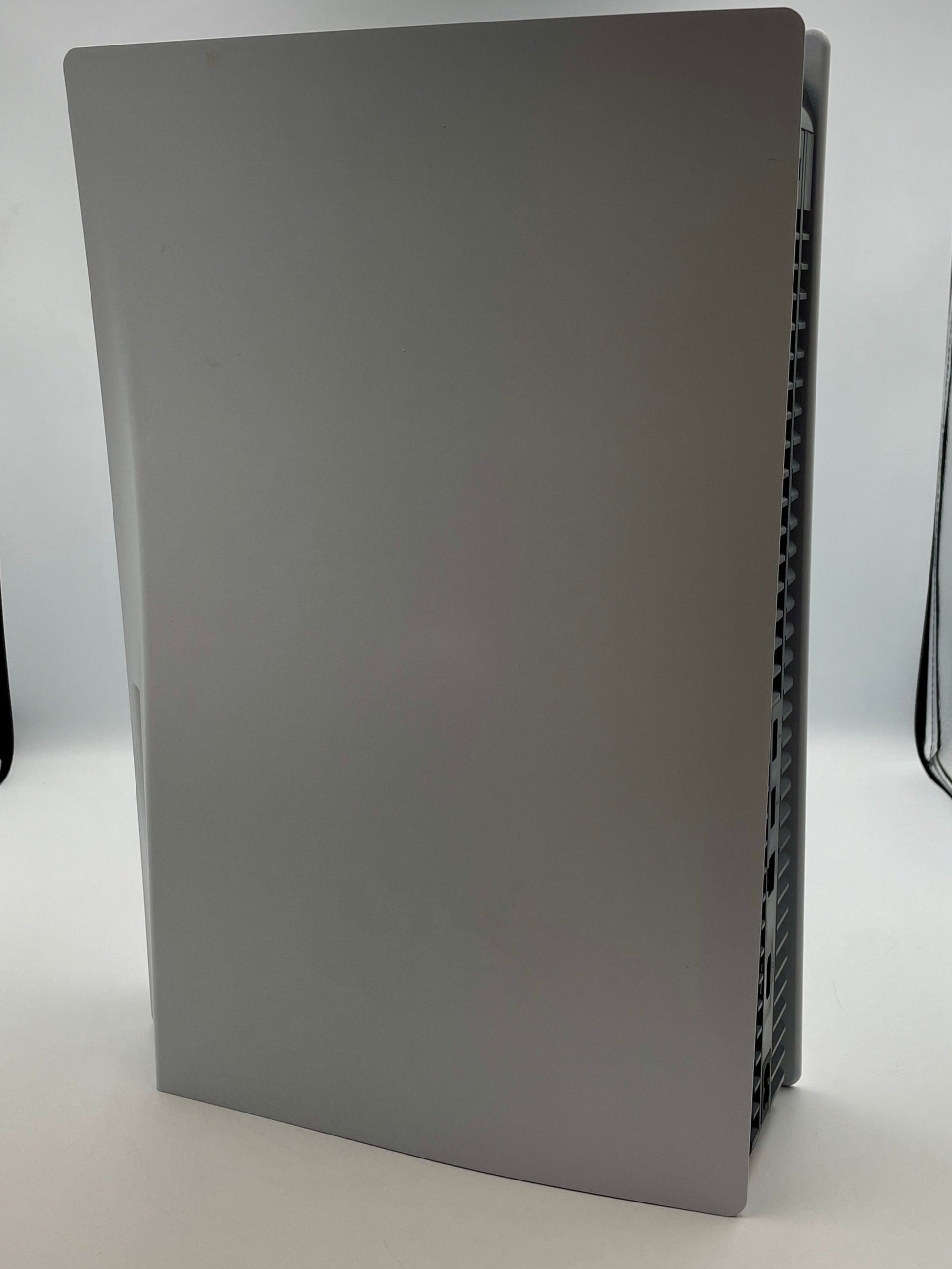 White electronic device on a white surface with a neutral background