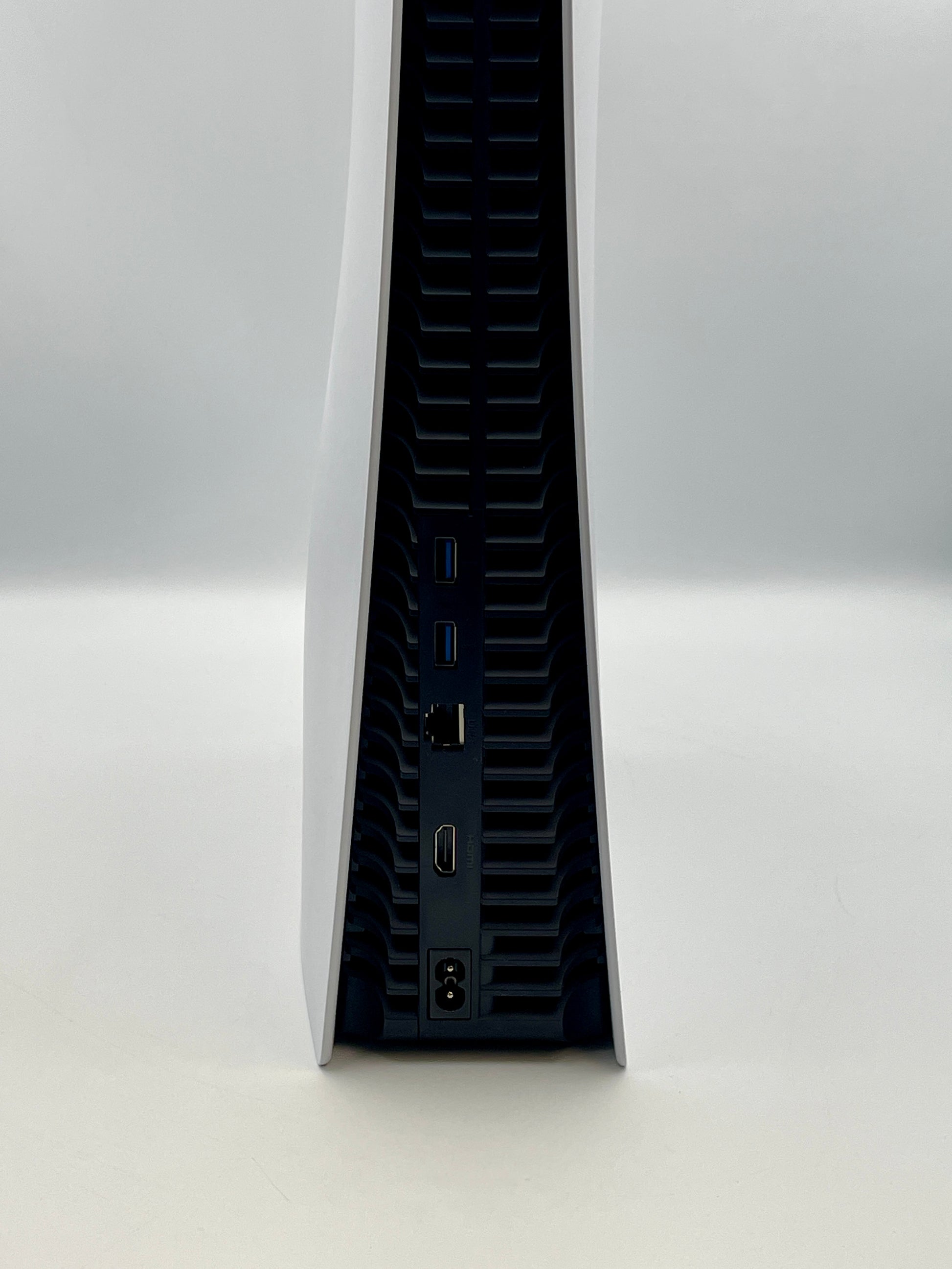 Side view of a PS5 with ports on a white background