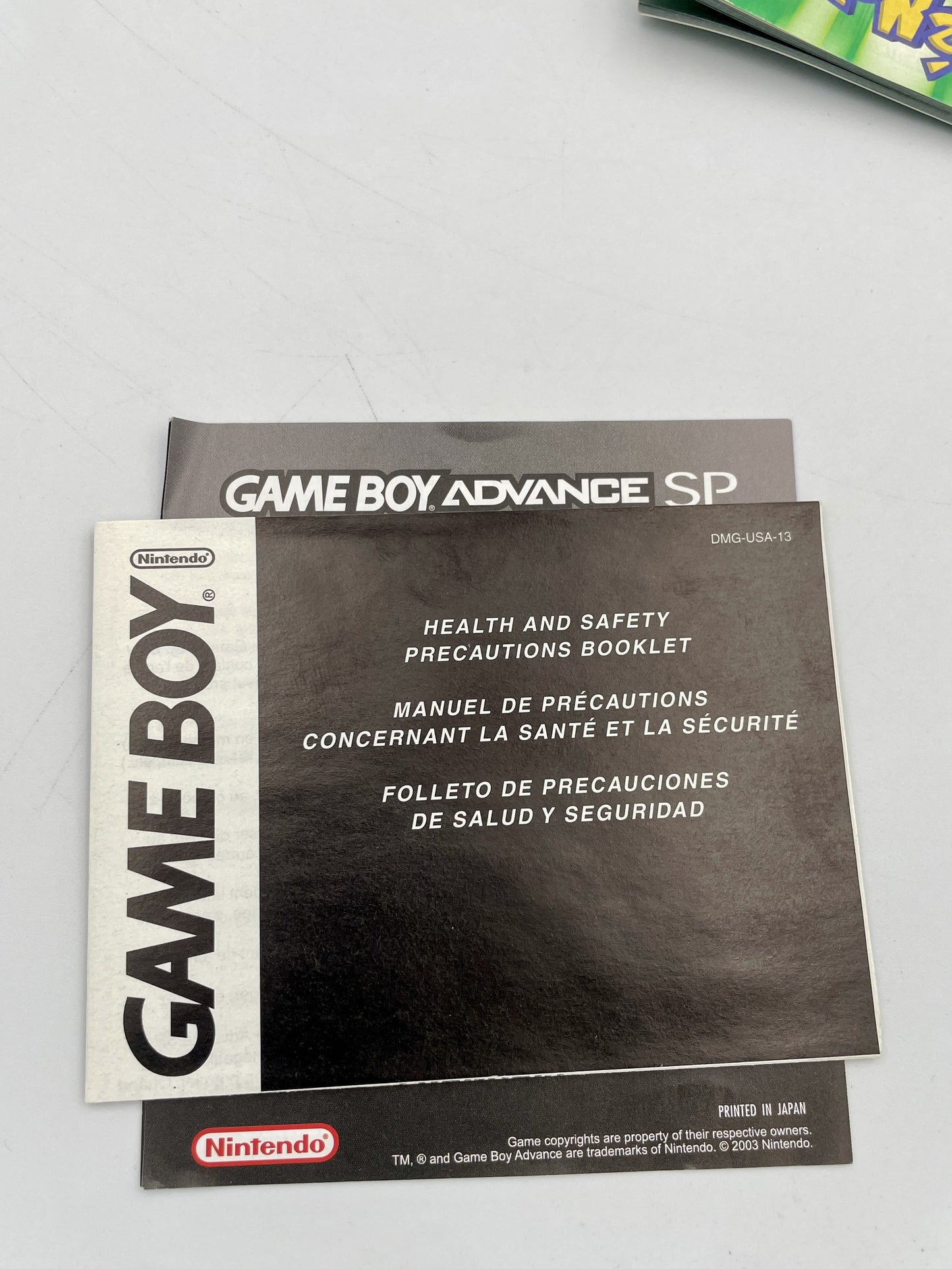Nintendo Game Boy and Game Boy Advance SP manuals on a gray background