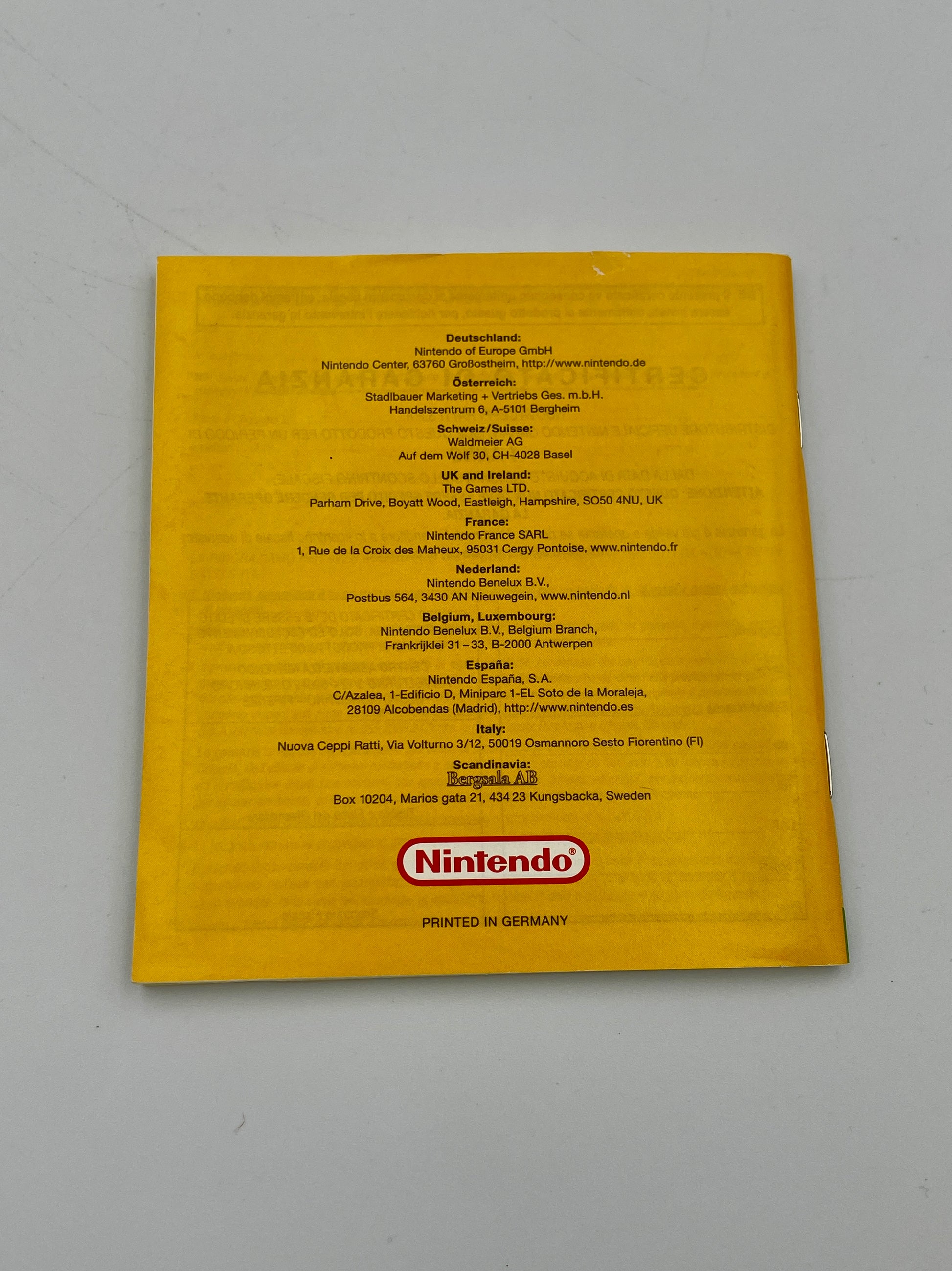Yellow Nintendo product box with text and logo on a gray background