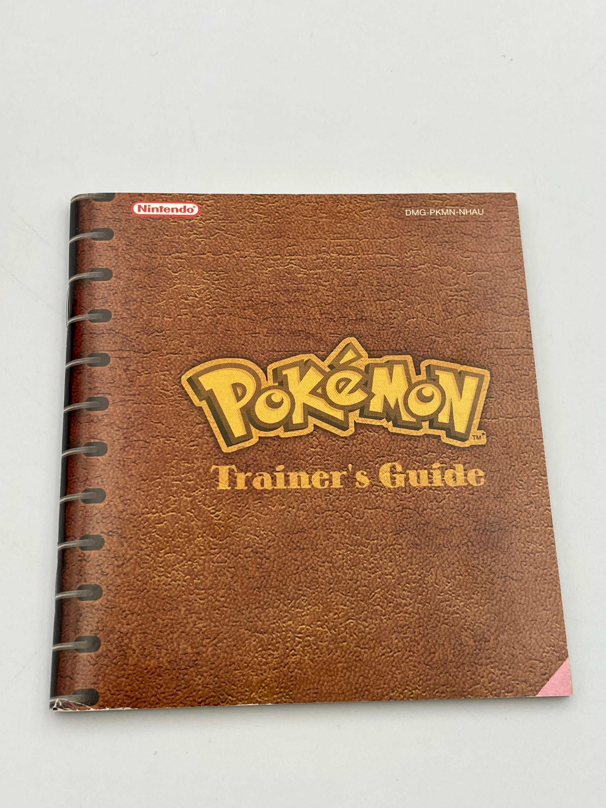Brown notebook with 'Pokémon Trainer's Guide' on a white background