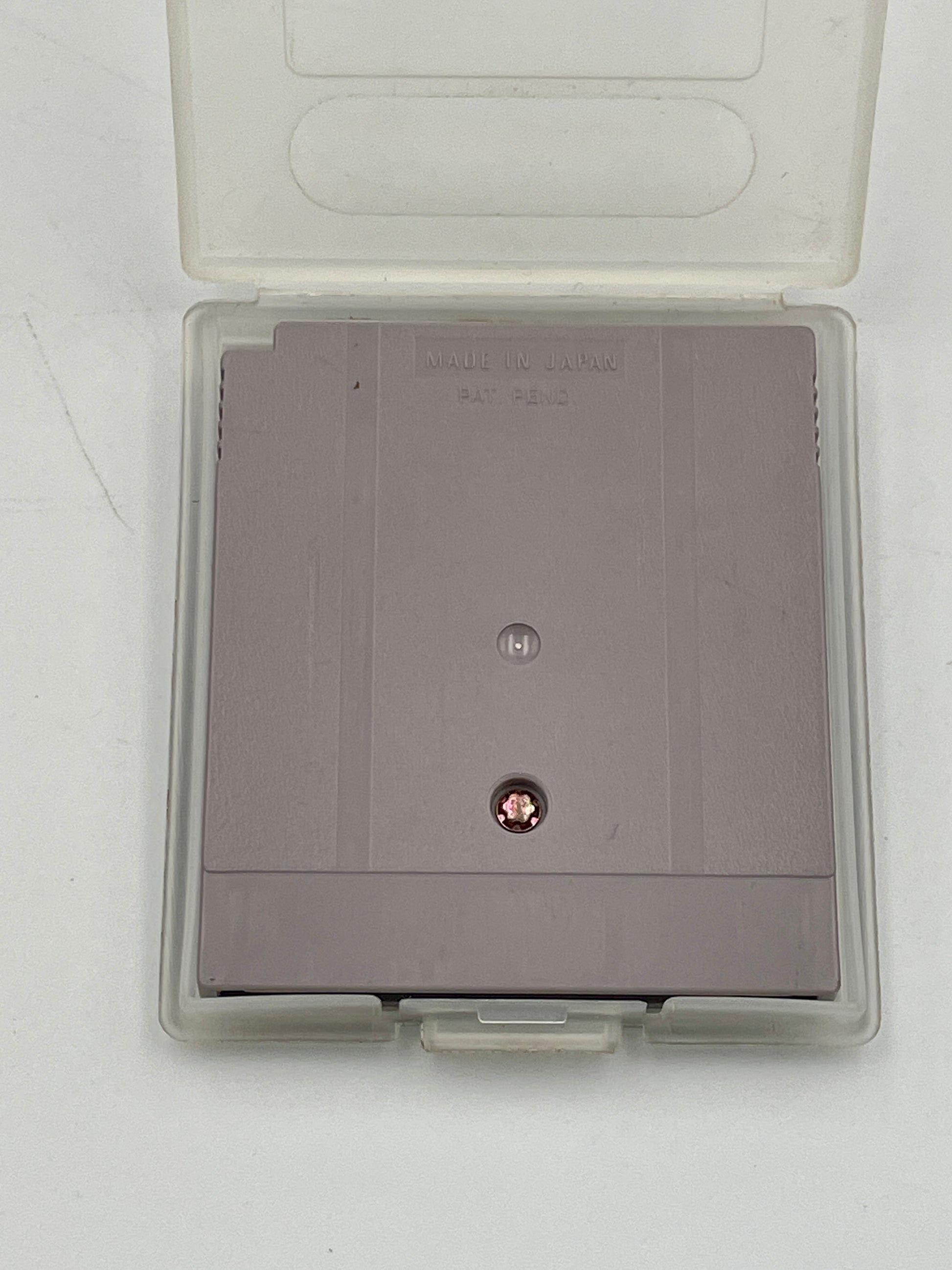 Gray game cartridge in a transparent case on a white background
