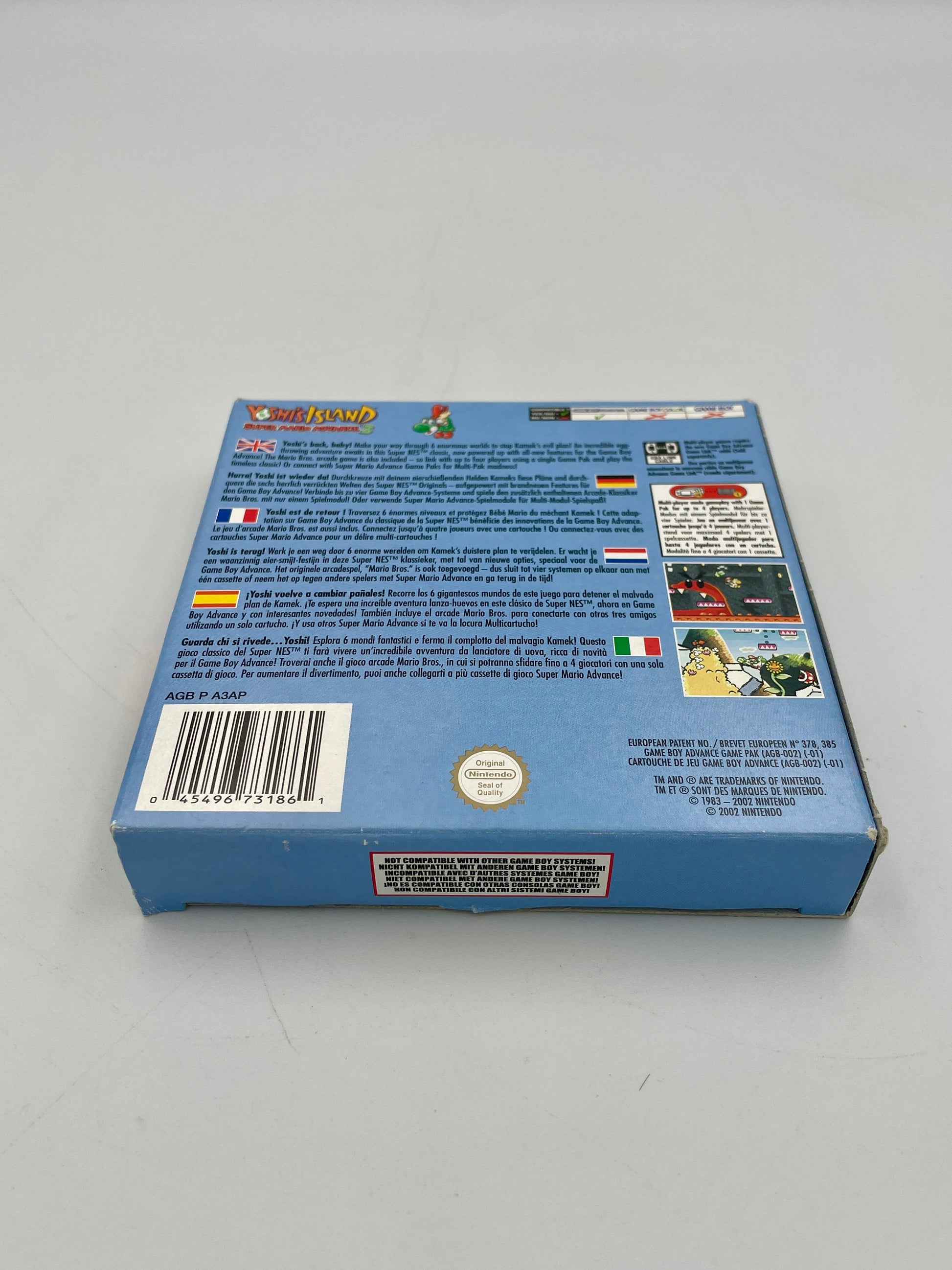 Back view of a blue game cartridge packaging with text and graphics on a gray background