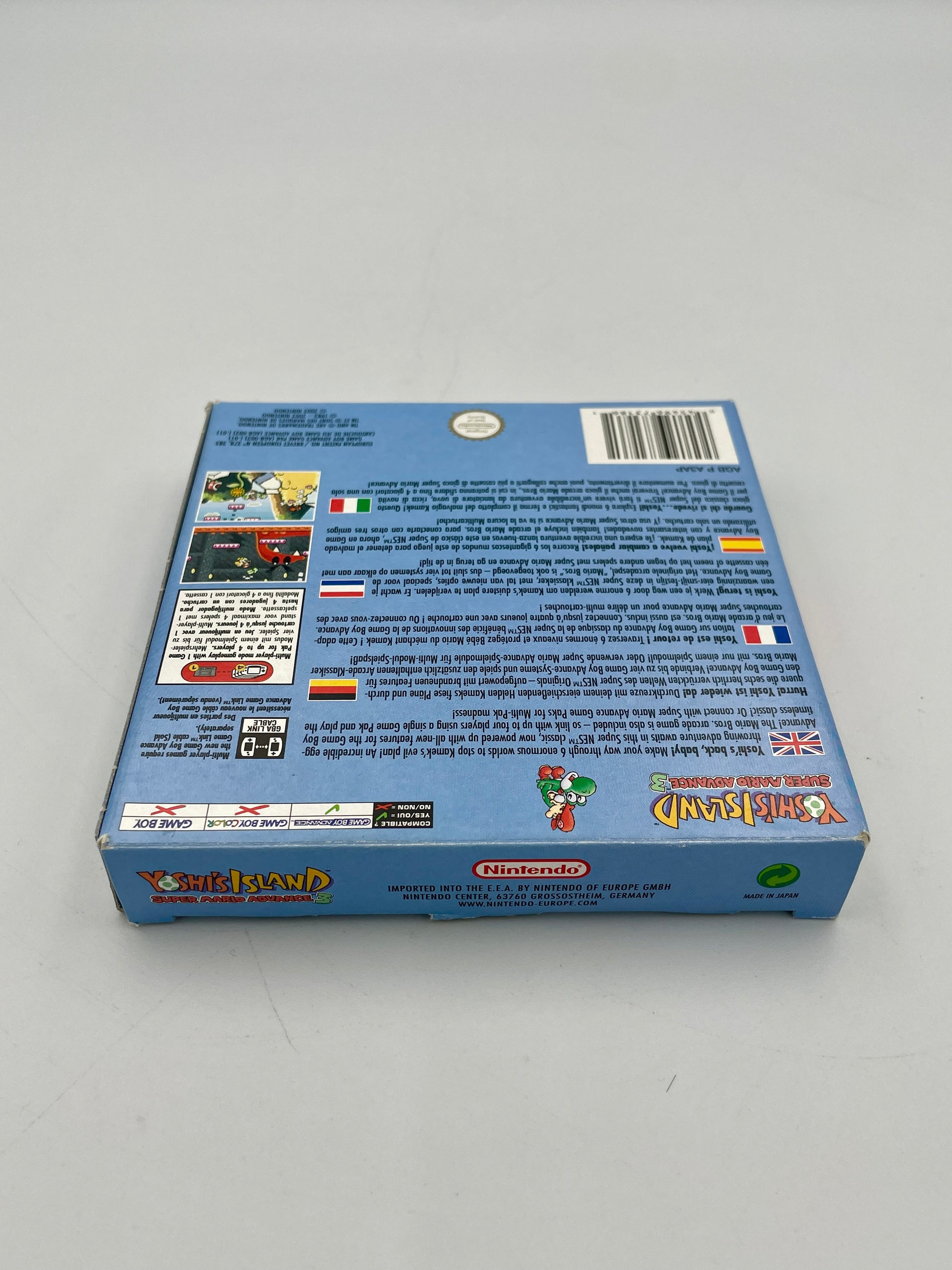 Back view of a blue box with text and graphics on a gray background