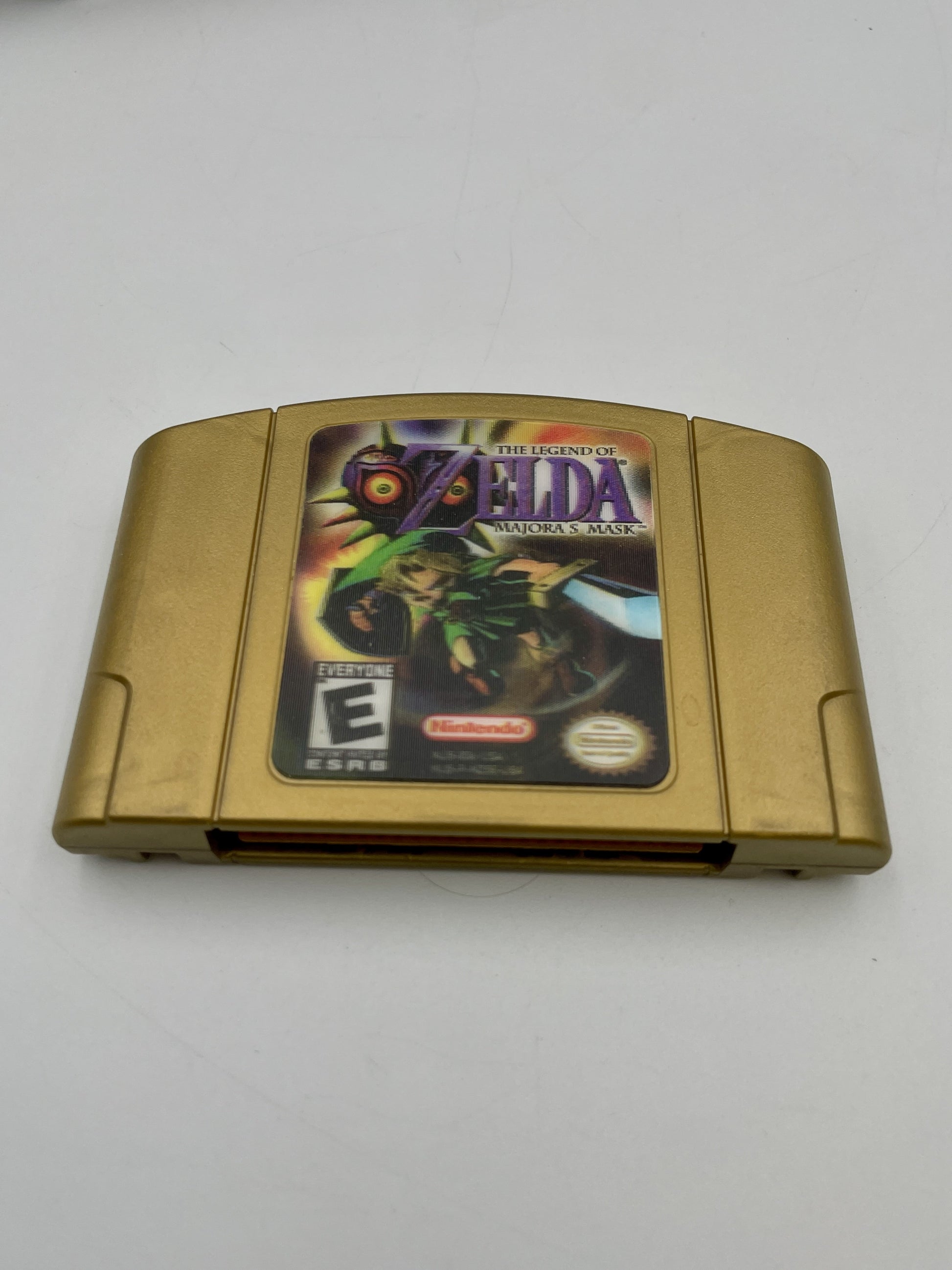 Gold game cartridge with 'The Legend of Zelda' cover on a white background